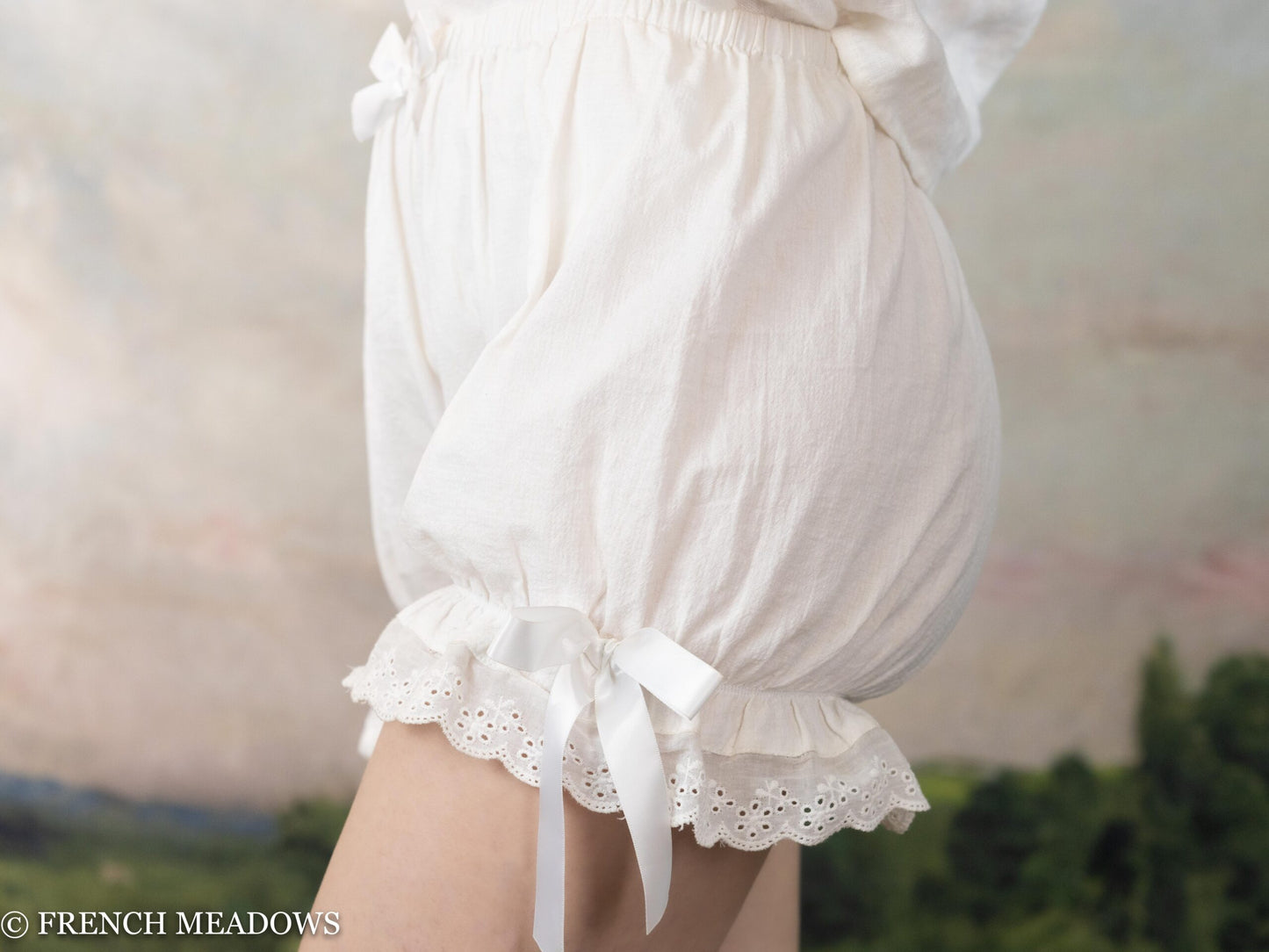 Victorian Bloomers with white lace trim and bow detail, elastic waistband and ruffle hem shown from side view