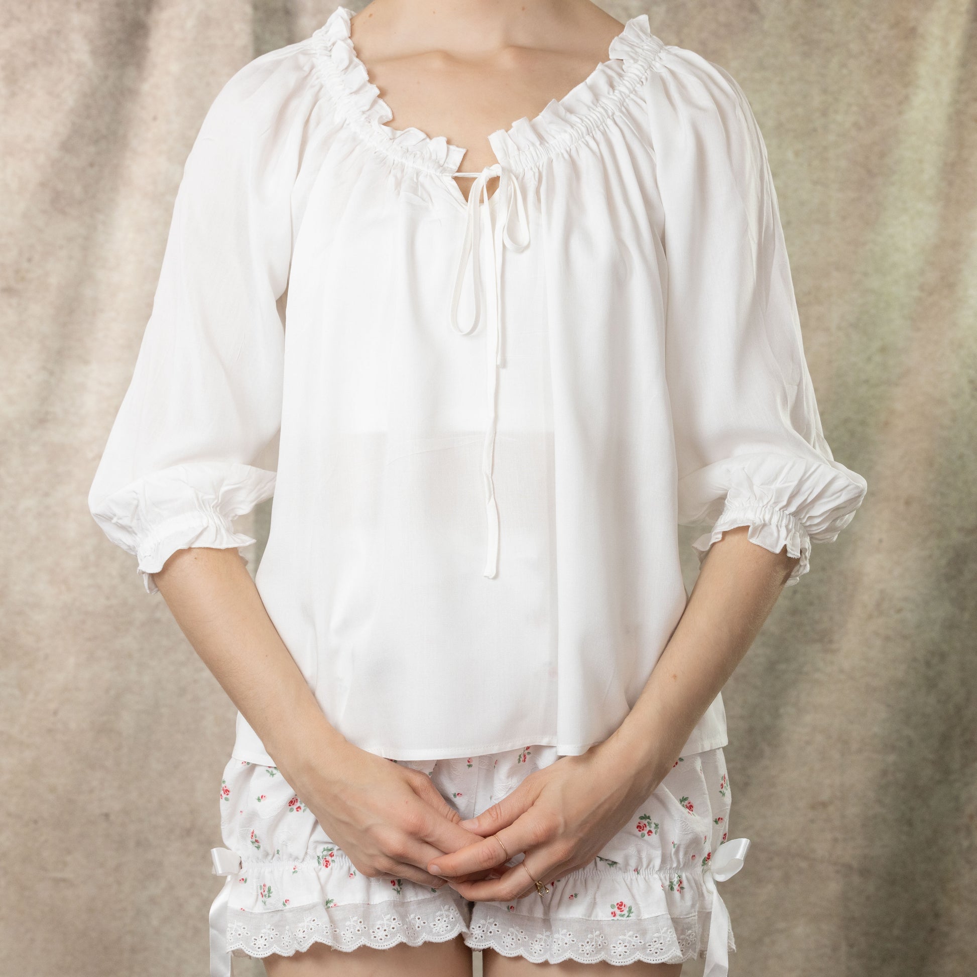 model wearing white blouse with floral bloomers