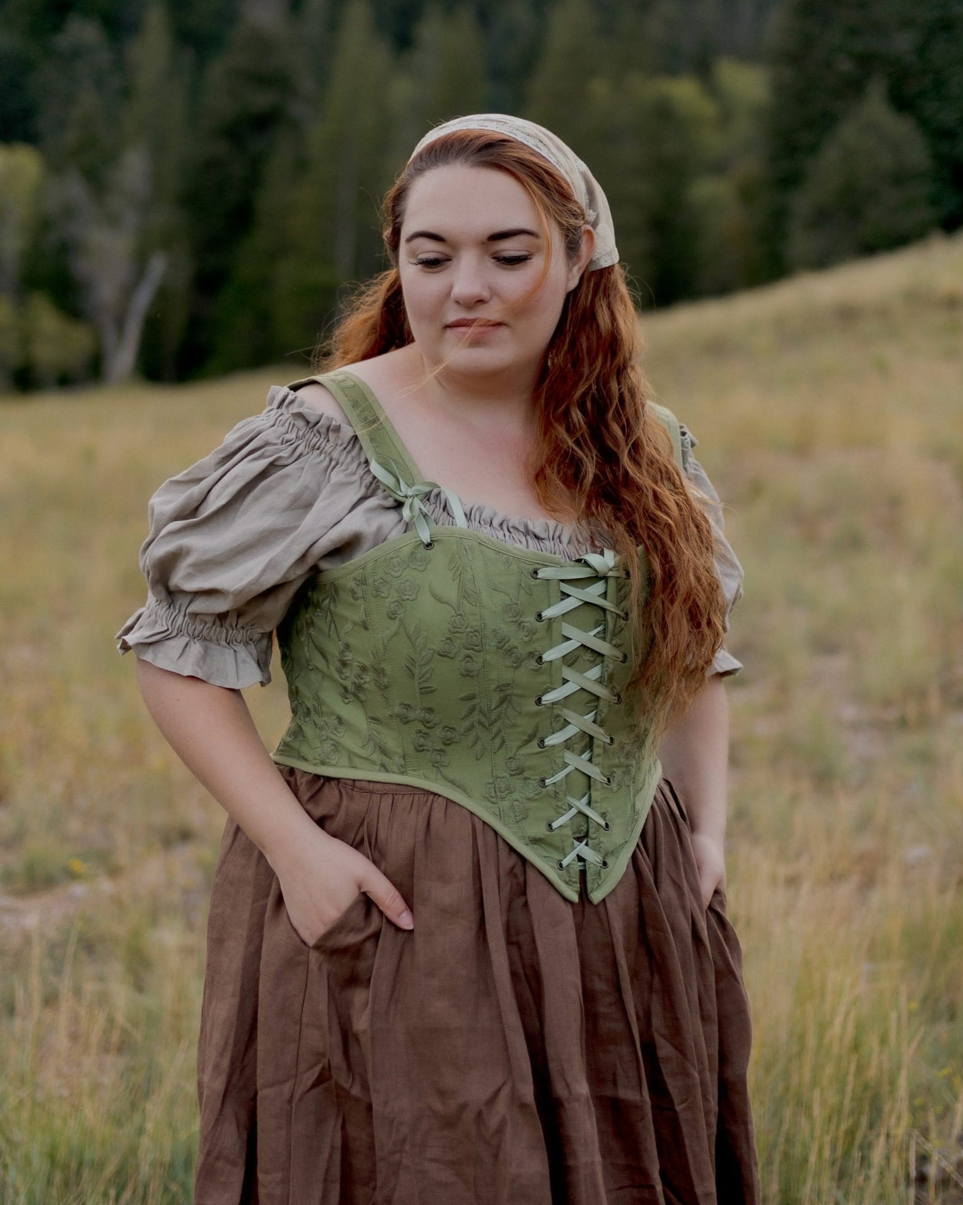 plus size model wearing moss green renaissance faire corset