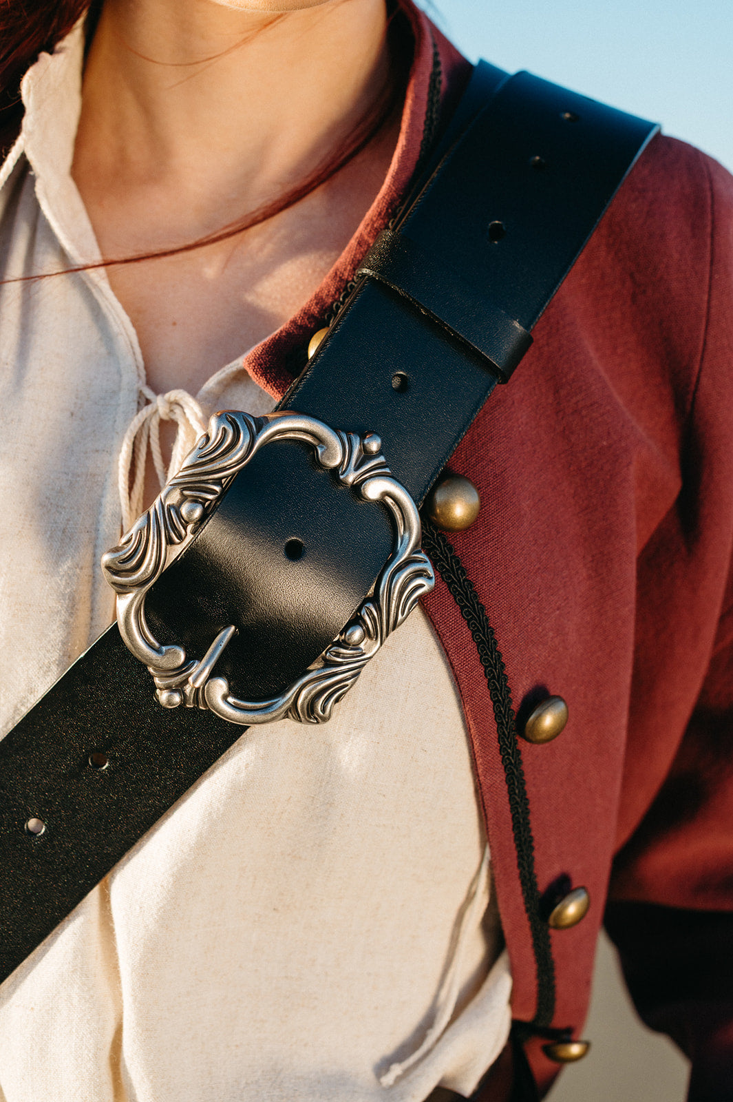 Close-up of a person wearing a Leather Pirate Belt with an ornate silver buckle and vintage-inspired clothing.