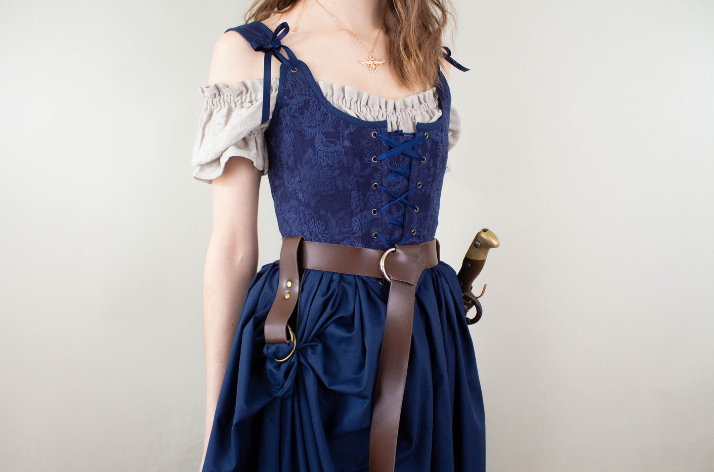 Woman wearing Handmade Navy Blue Embroidered Floral Corset with lace-up front and tied shoulder straps