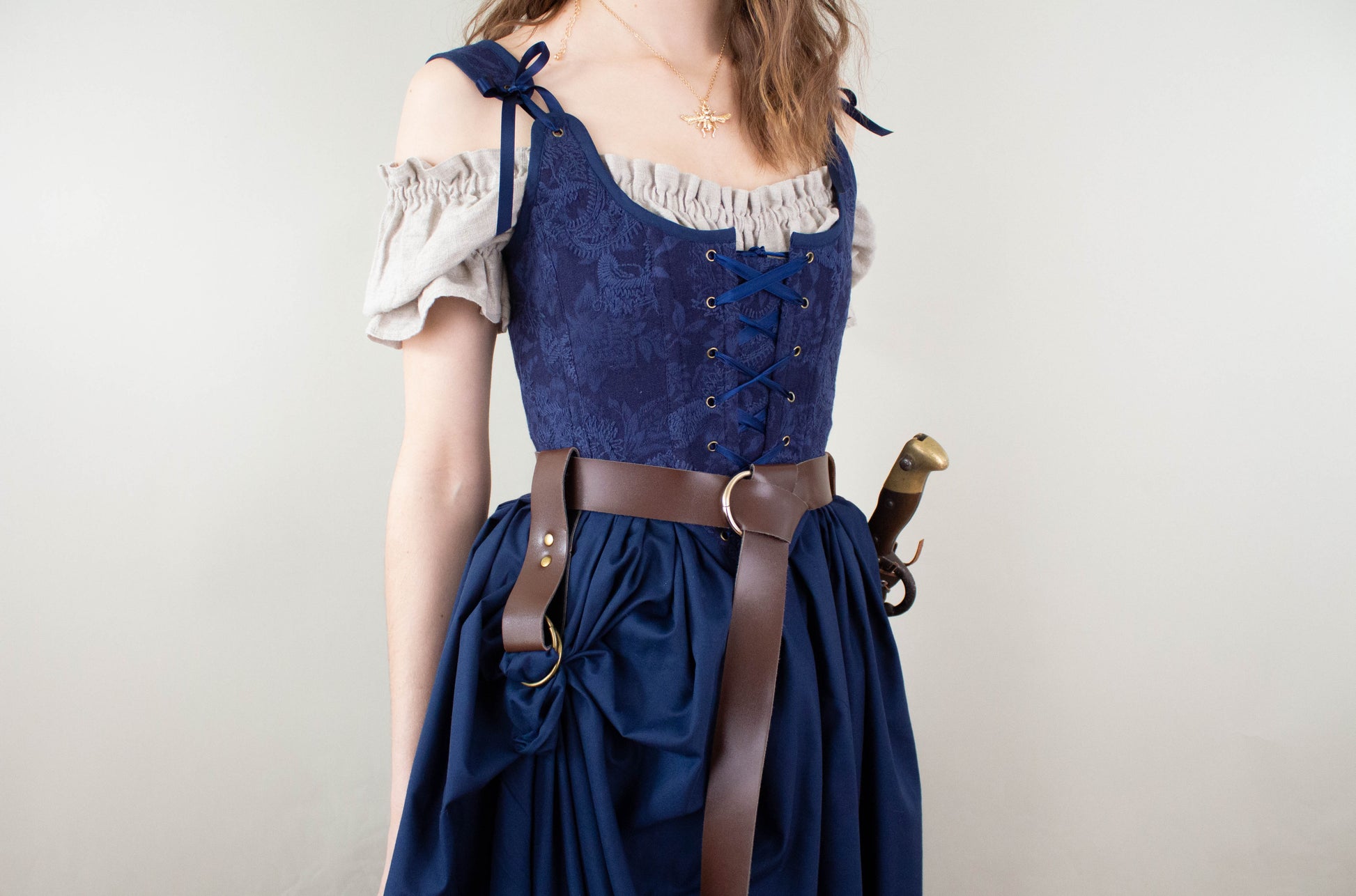 Woman wearing Handmade Navy Blue Embroidered Floral Corset with lace-up front and tied shoulder straps