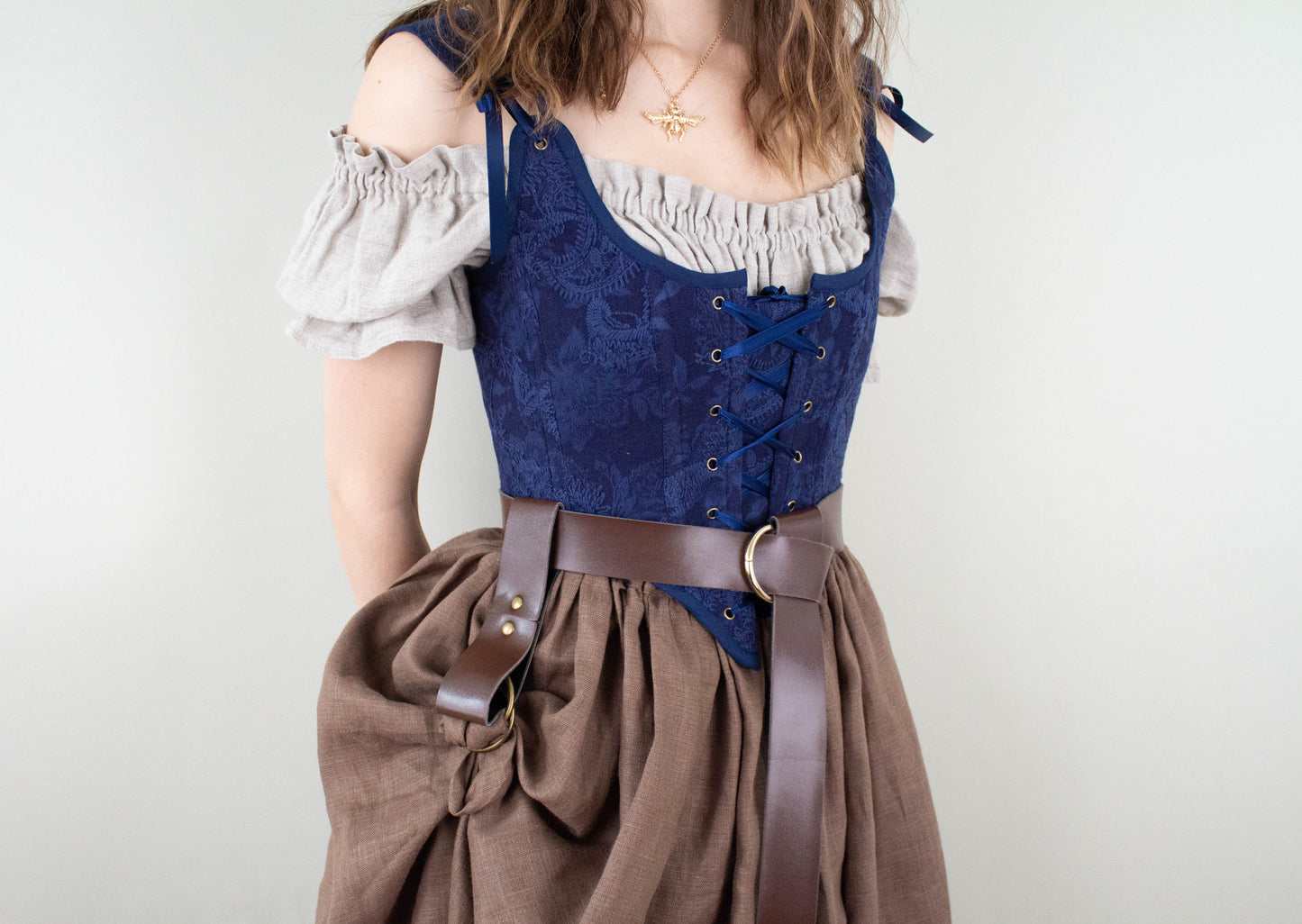 Woman wearing a Handmade Navy Blue Embroidered Floral Corset with lace-up front and off-shoulder blouse