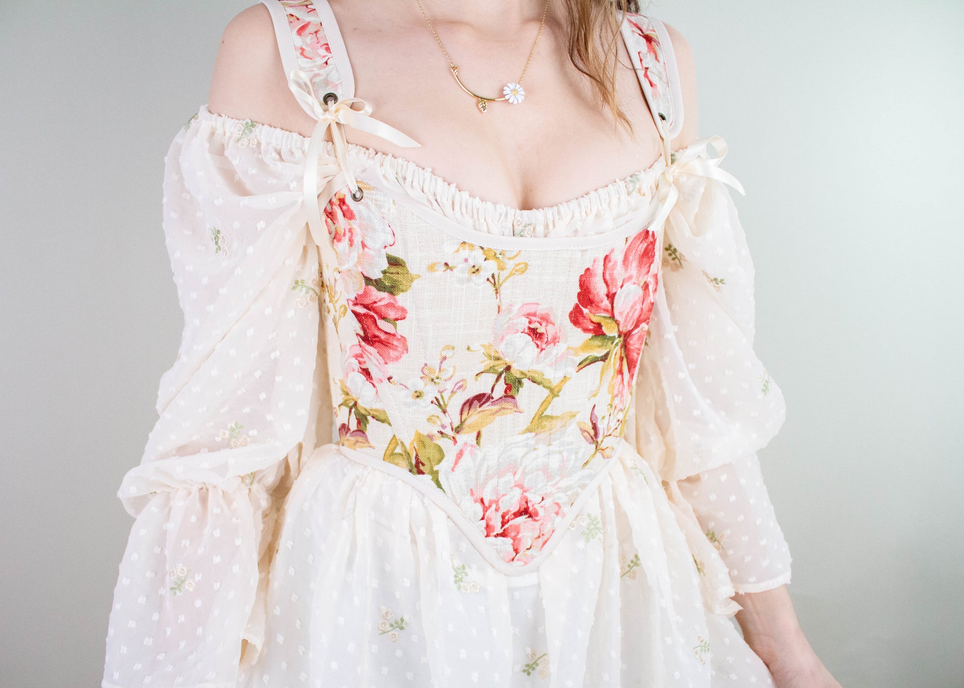 Handmade Covington Tea Rose Corset with pink floral bodice and sheer off-shoulder sleeves in cottagecore cosplay style
