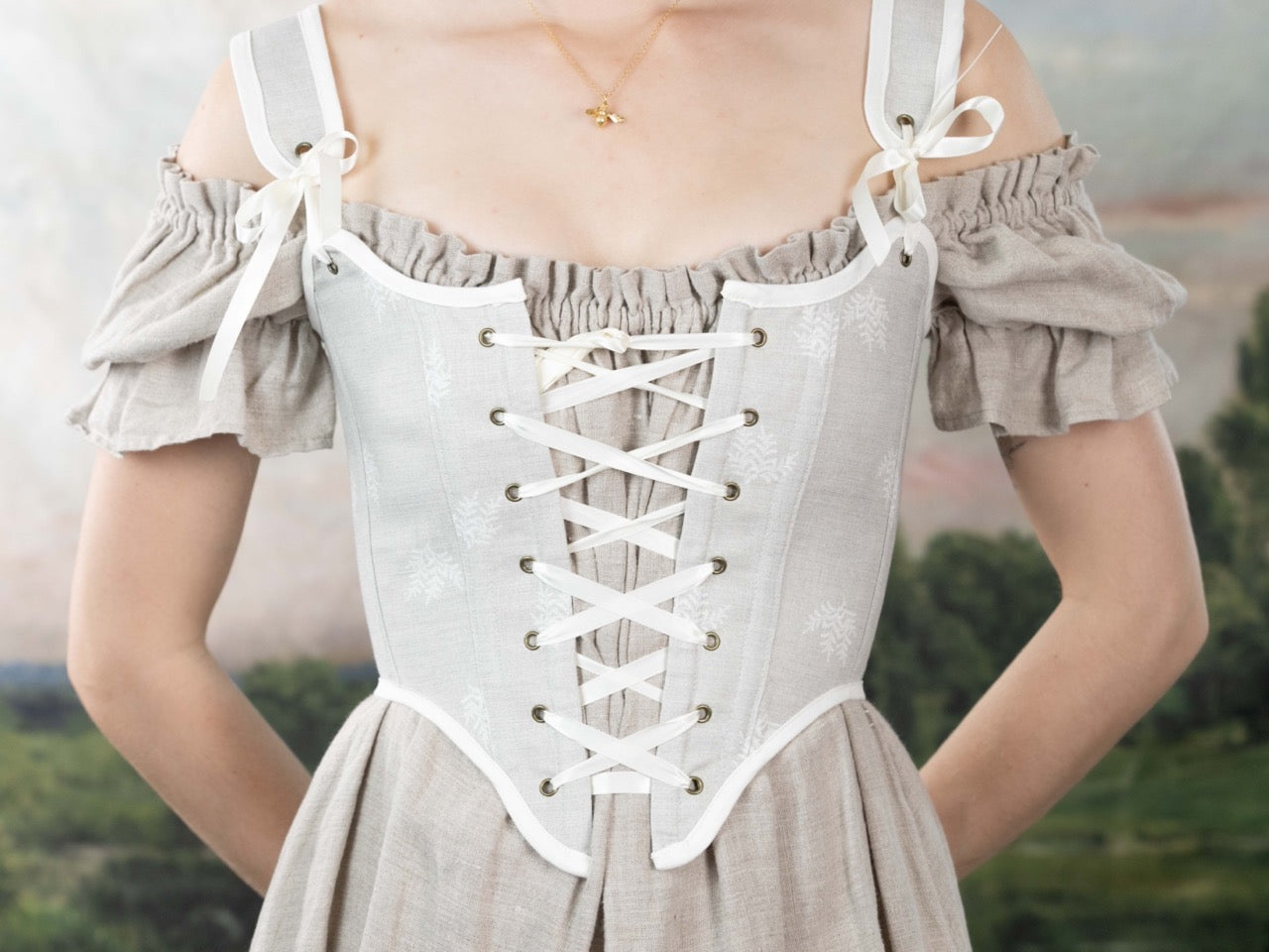 Close-up of a Handmade Beige Fern Corset with laced front worn over an off-shoulder beige linen dress