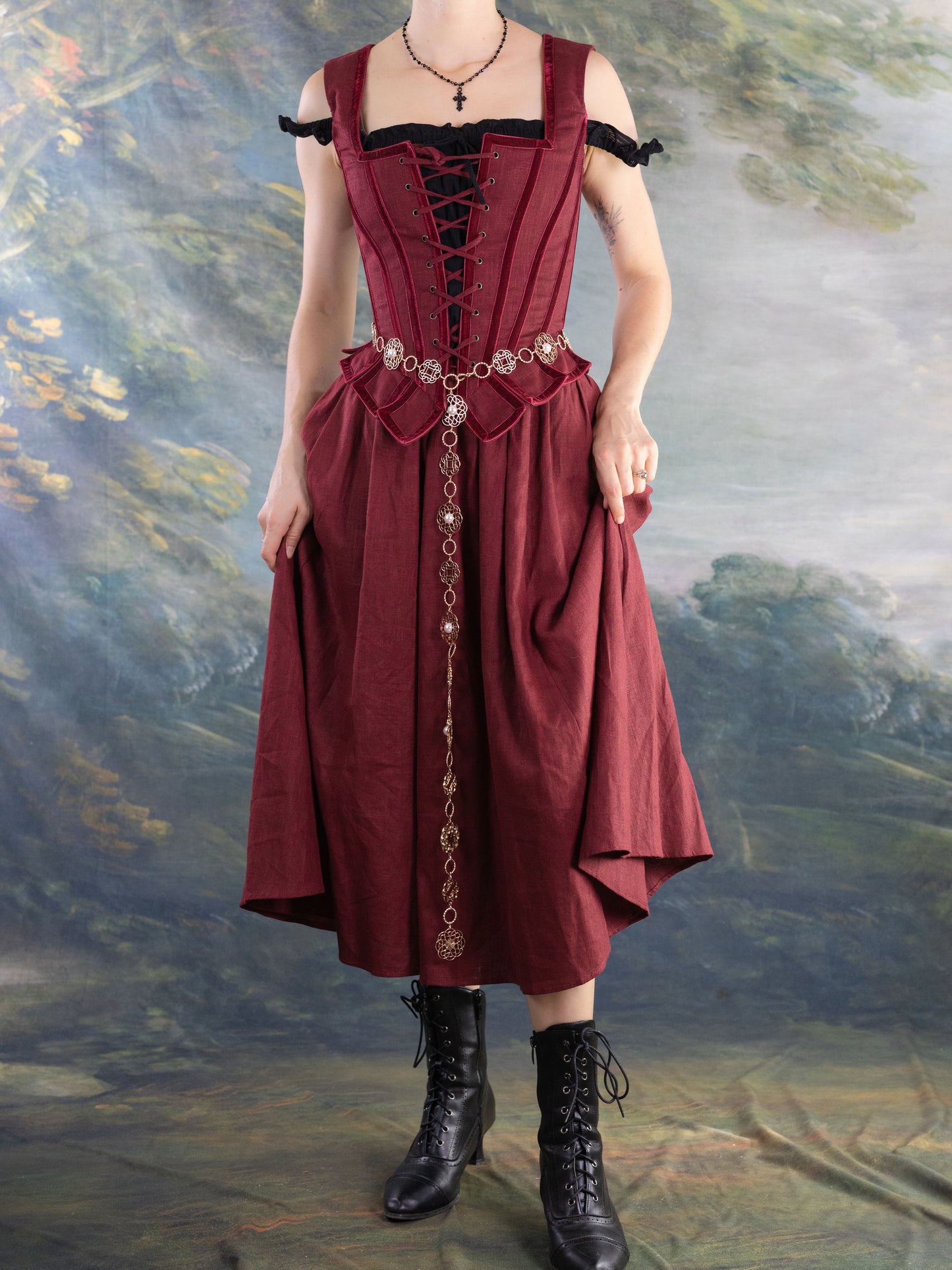 Model wearing a burgundy dress with lace-up bodice and black Lacey Chemisette Tank under layered with accessories