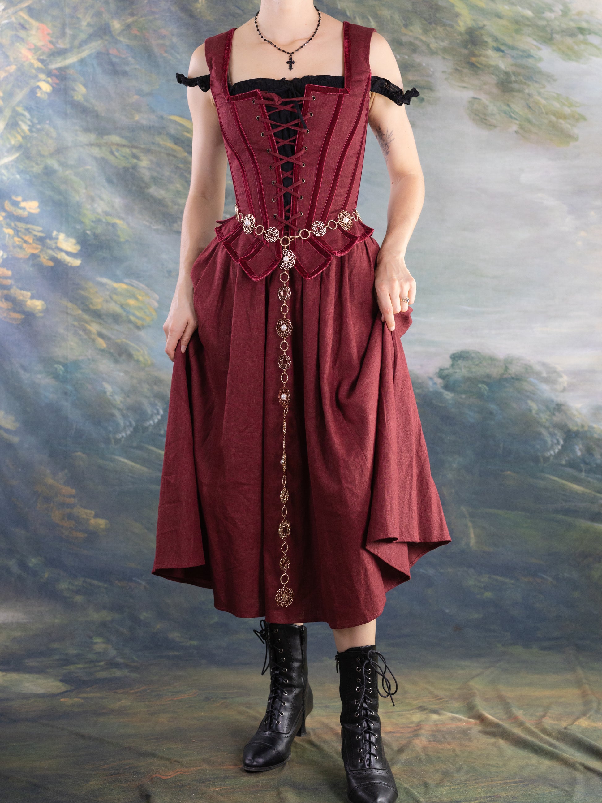Model wearing a burgundy dress with lace-up bodice and black Lacey Chemisette Tank under layered with accessories