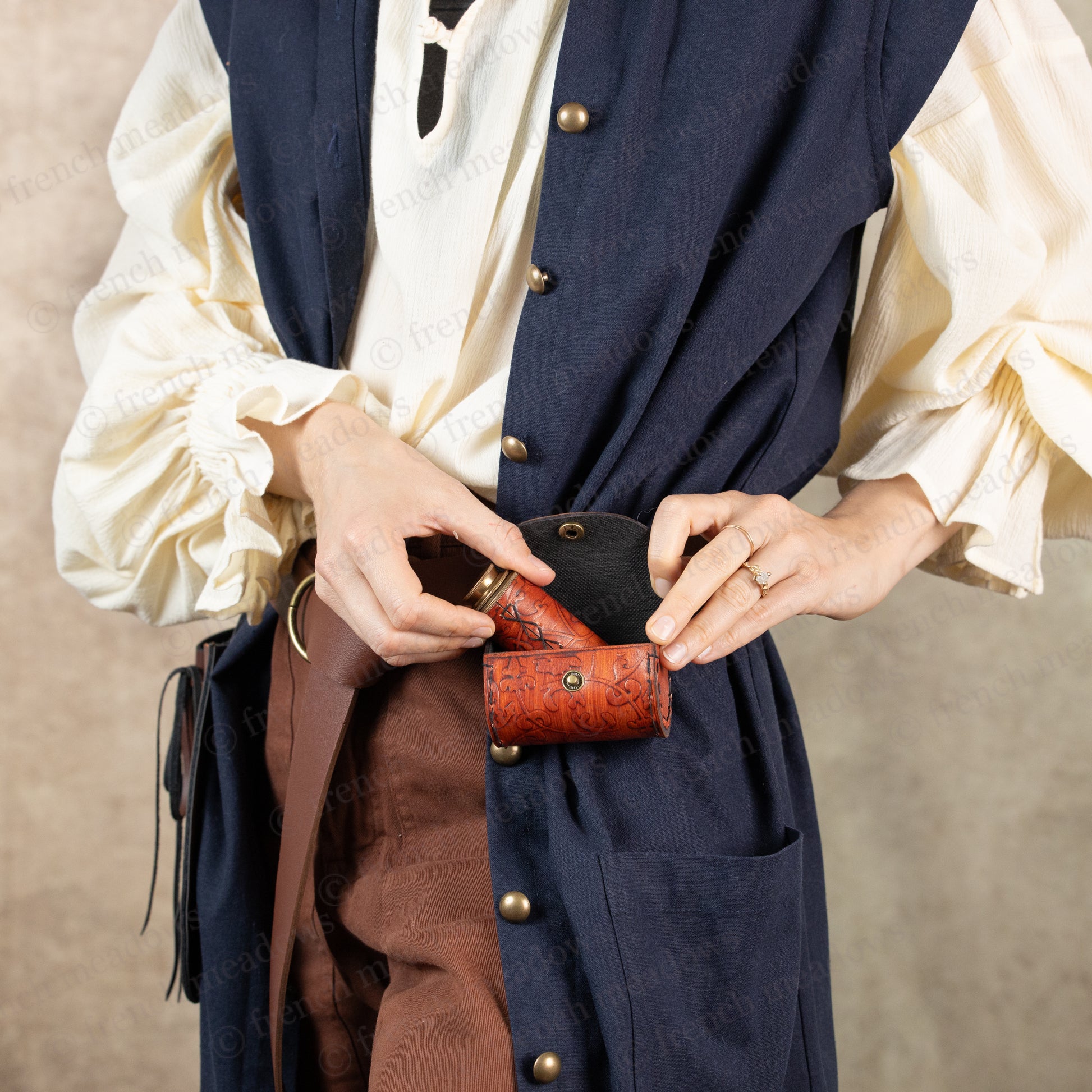 model showing how pirate's spyglass goes into included belt pouch for spyglass