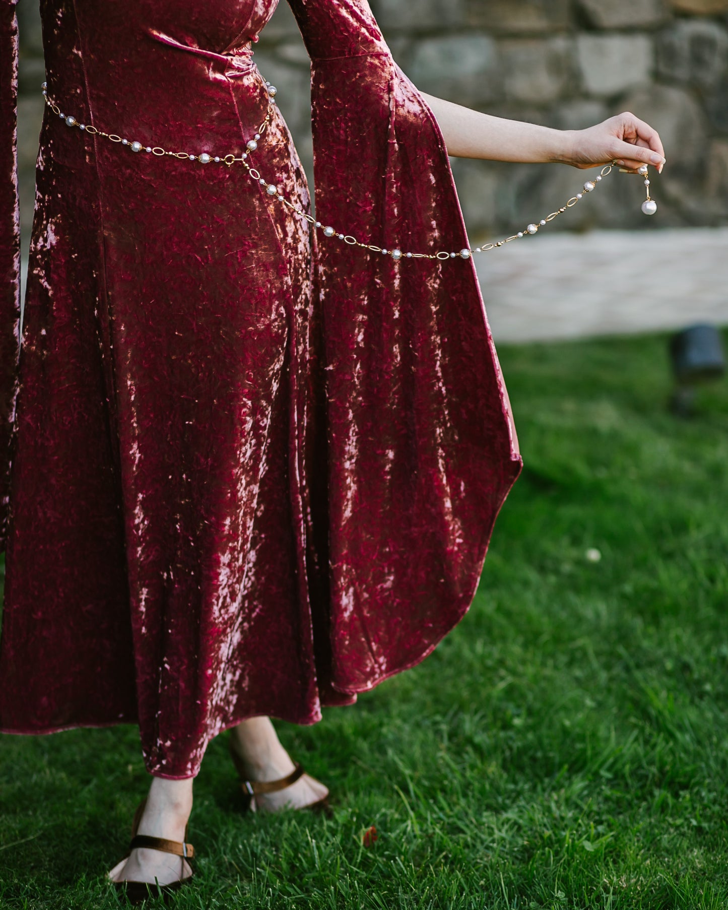 Pearl Medieval Chain Belt worn over a red velvet medieval-style dress with ornate pearls and twisted metal rings