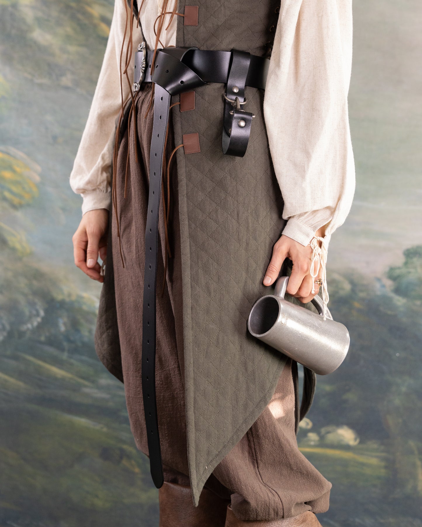 Person wearing medieval outfit with Heavy Duty Leather Tankard Strap holding metal mug by side