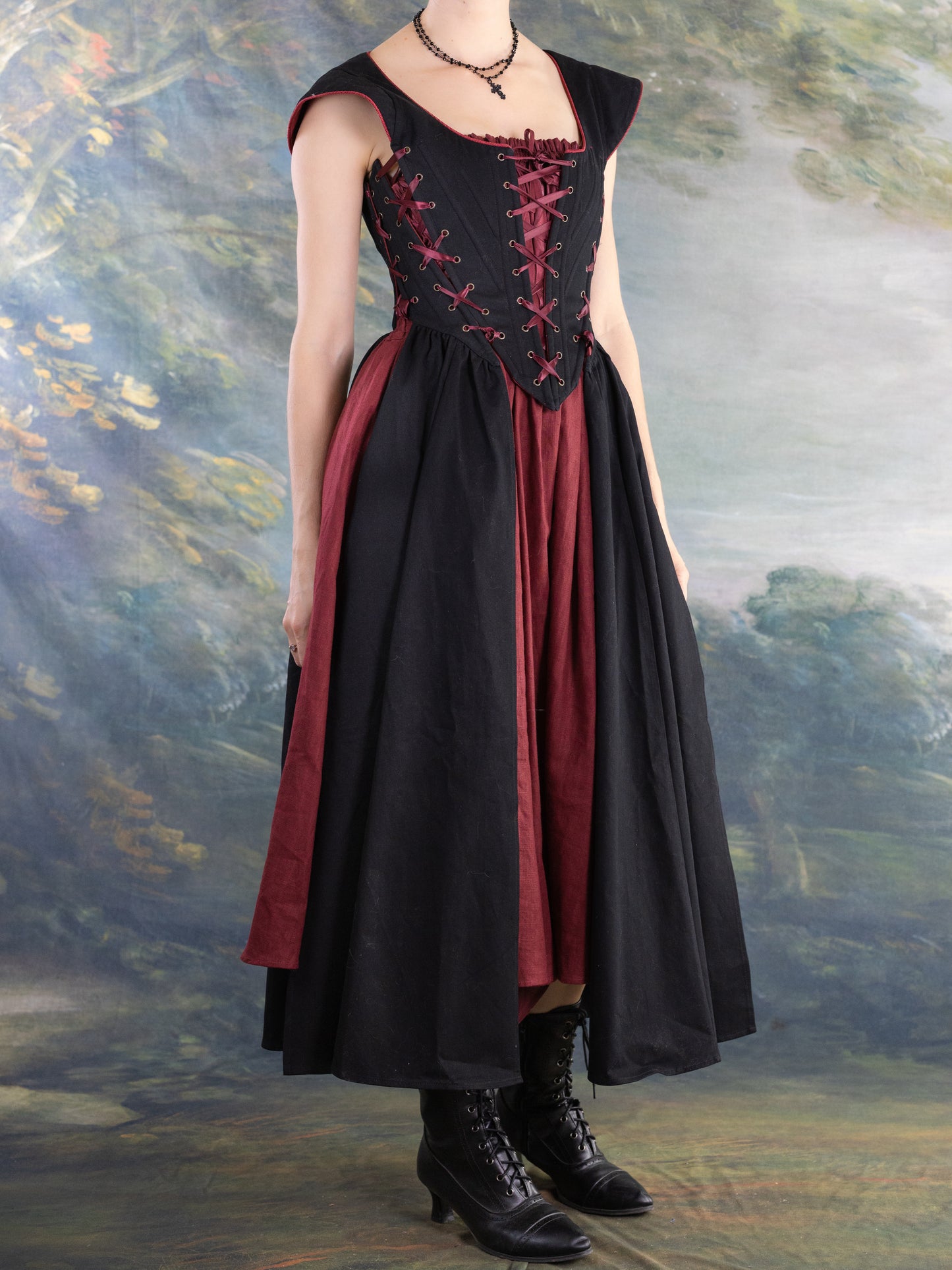 Black Vampire Slayer Corset Dress with structured bodice and lace-up detailing over a flowing black and deep red skirt.