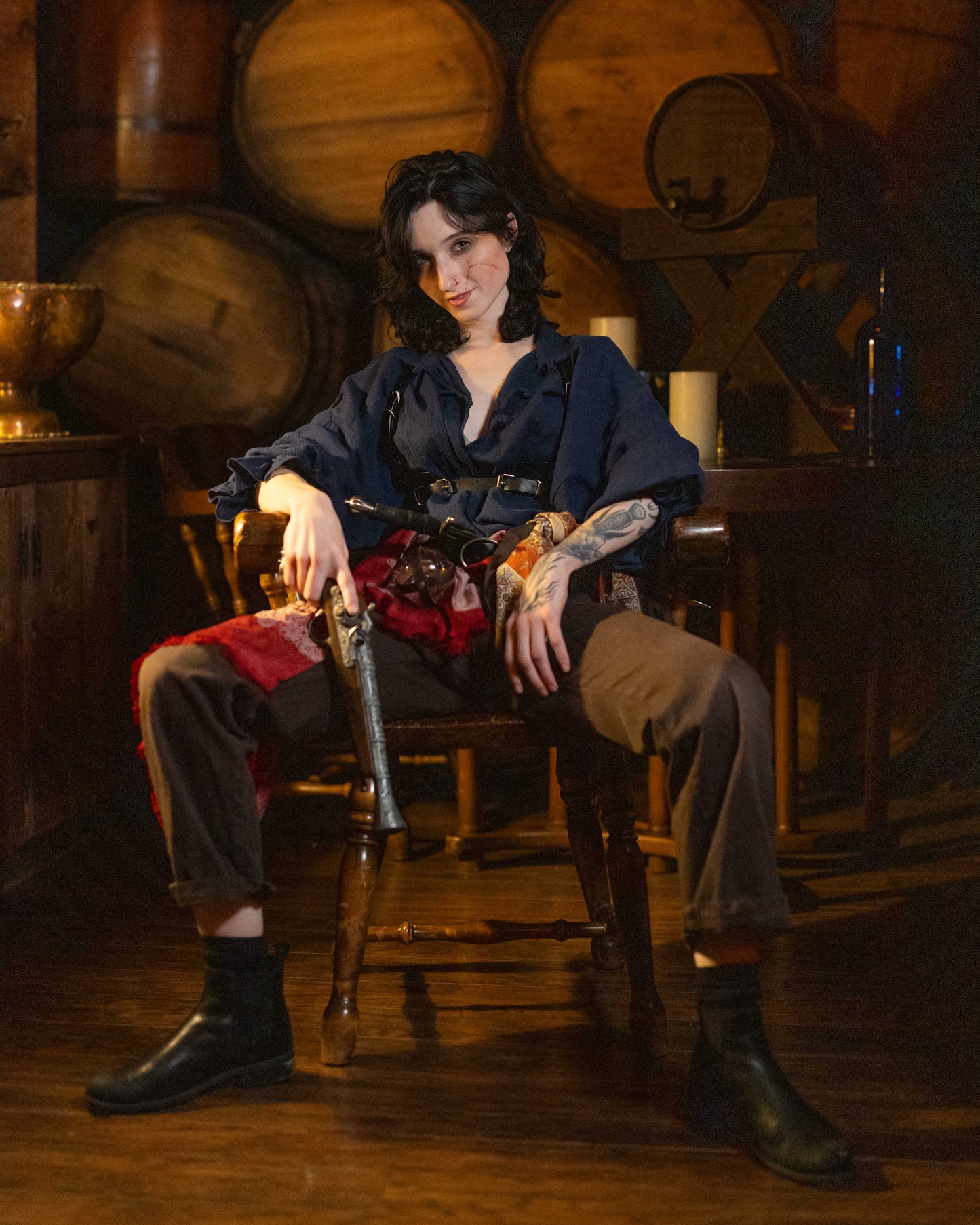 Person wearing Darcy Shirt PDF Sewing Pattern with billowing sleeves sitting confidently in rustic wooden room