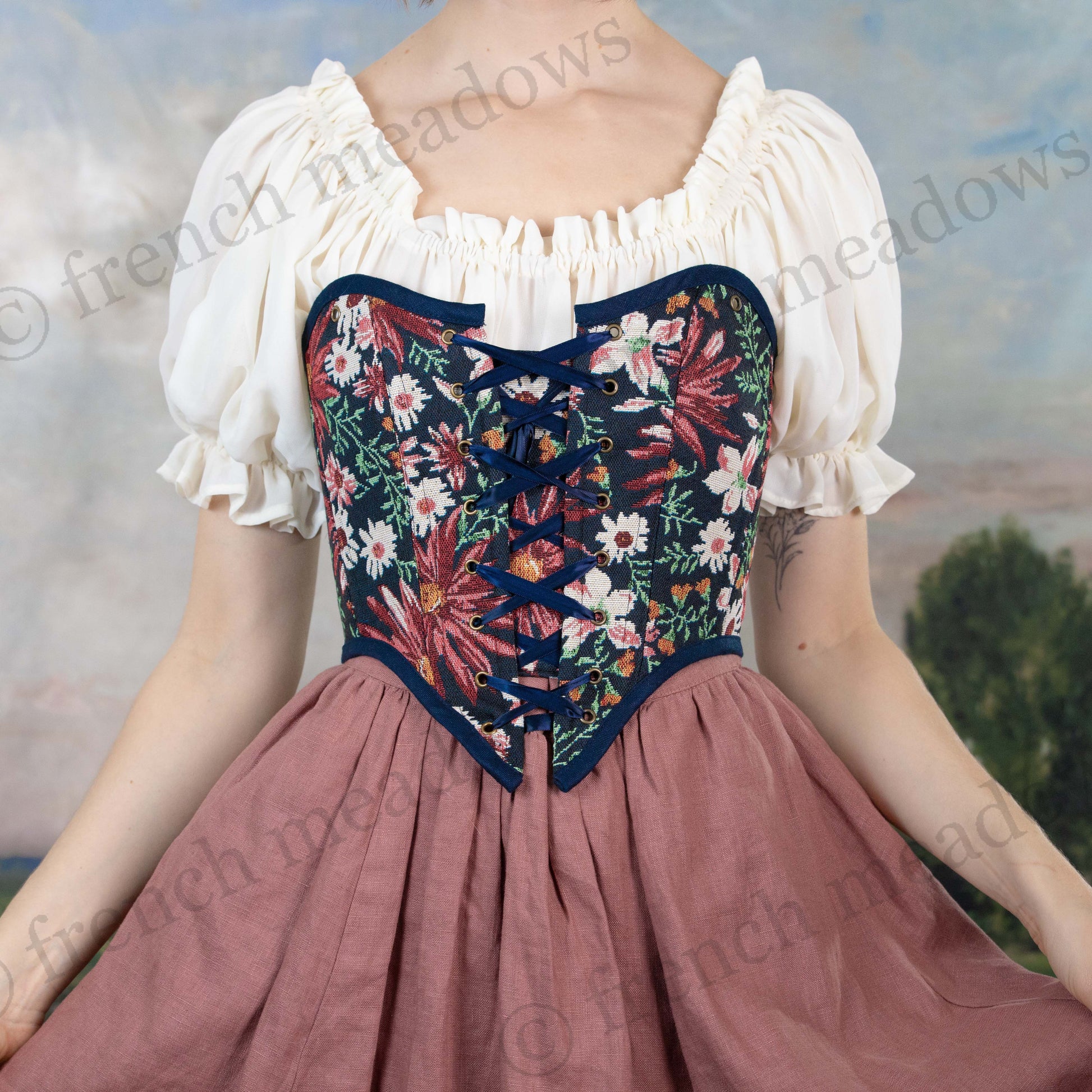 model wearing strapless dark blue floral bodice