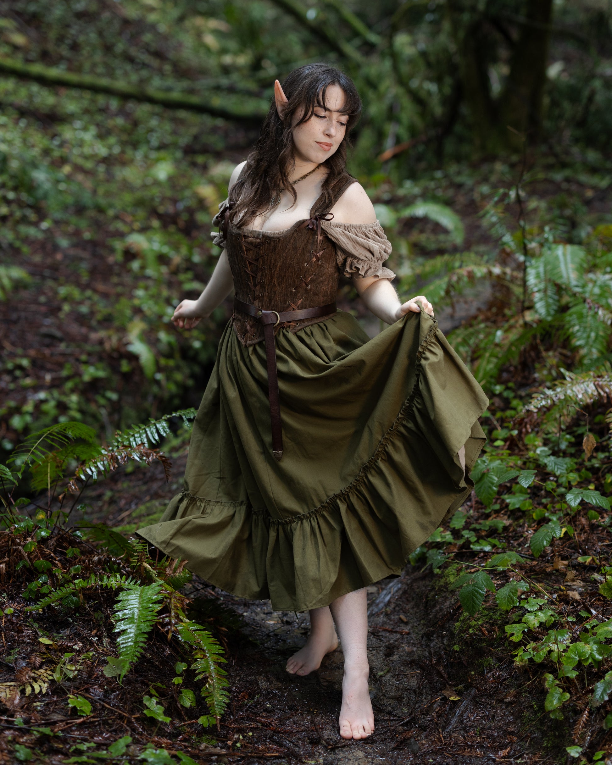 Brown Princess Stays corset worn in gallery 7 image, portrait 4000x5000, styled with forest setting and flowing skirt