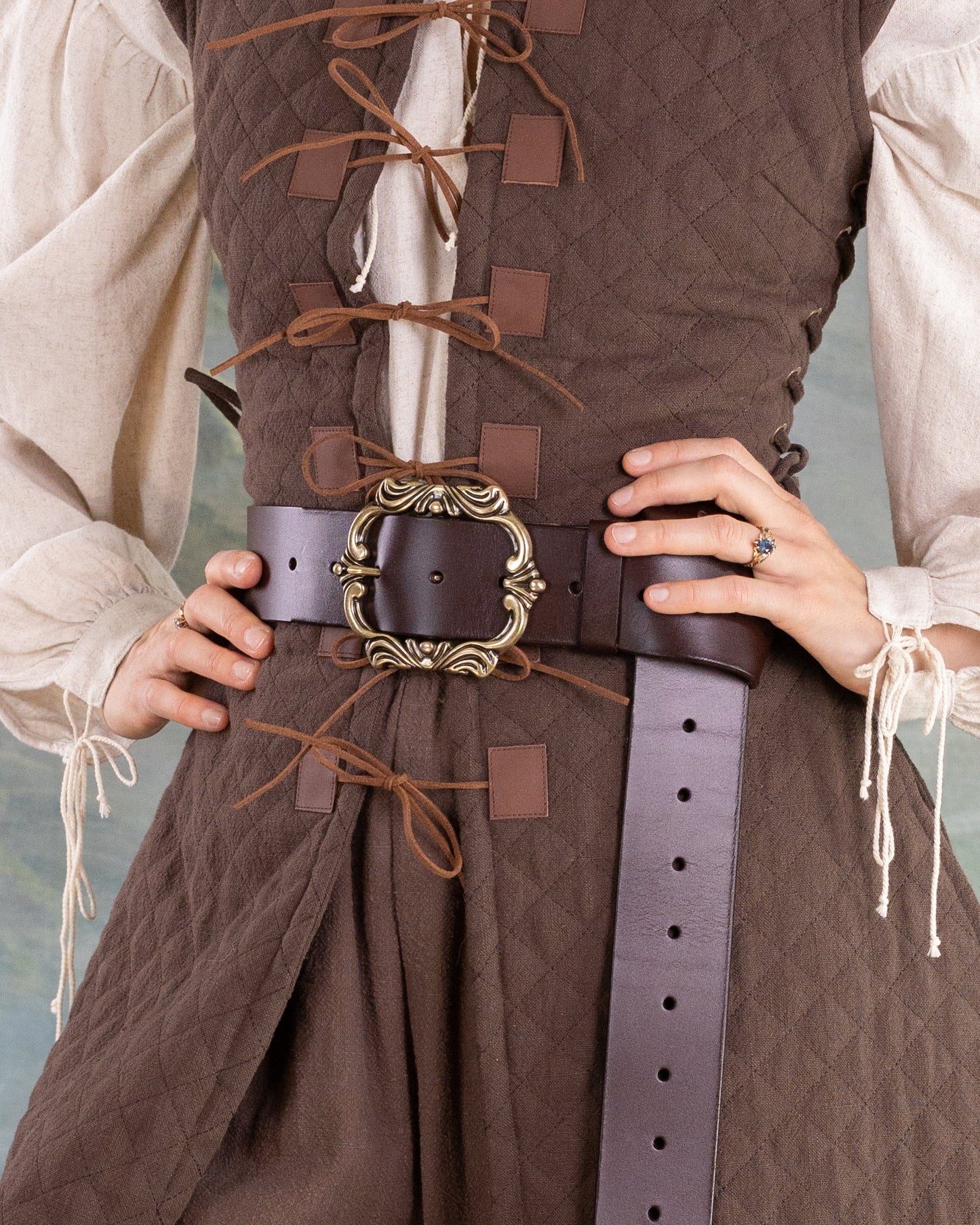 Leather Pirate Belt worn over a brown lace-up vest, featuring a wide strap and ornate antique buckle design