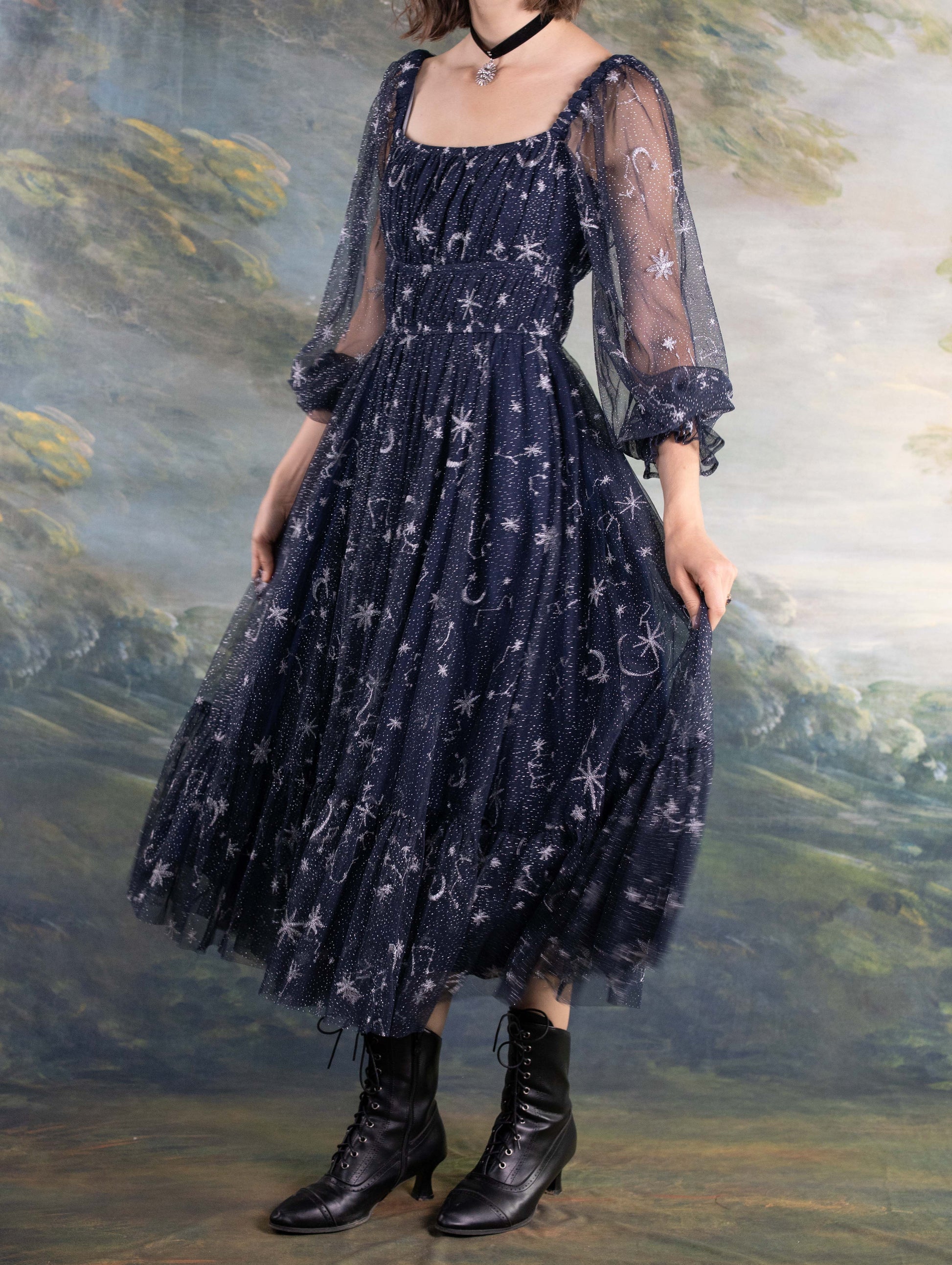 Celestial Tulle Dress featuring navy blue sheer fabric with star and moon patterns and a fitted waist silhouette.