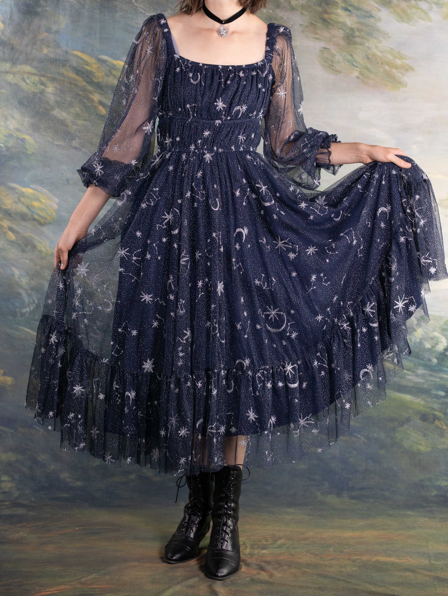 Celestial Tulle Dress in navy with sheer star and moon patterns and puffed sleeves creating a dreamy celestial look.