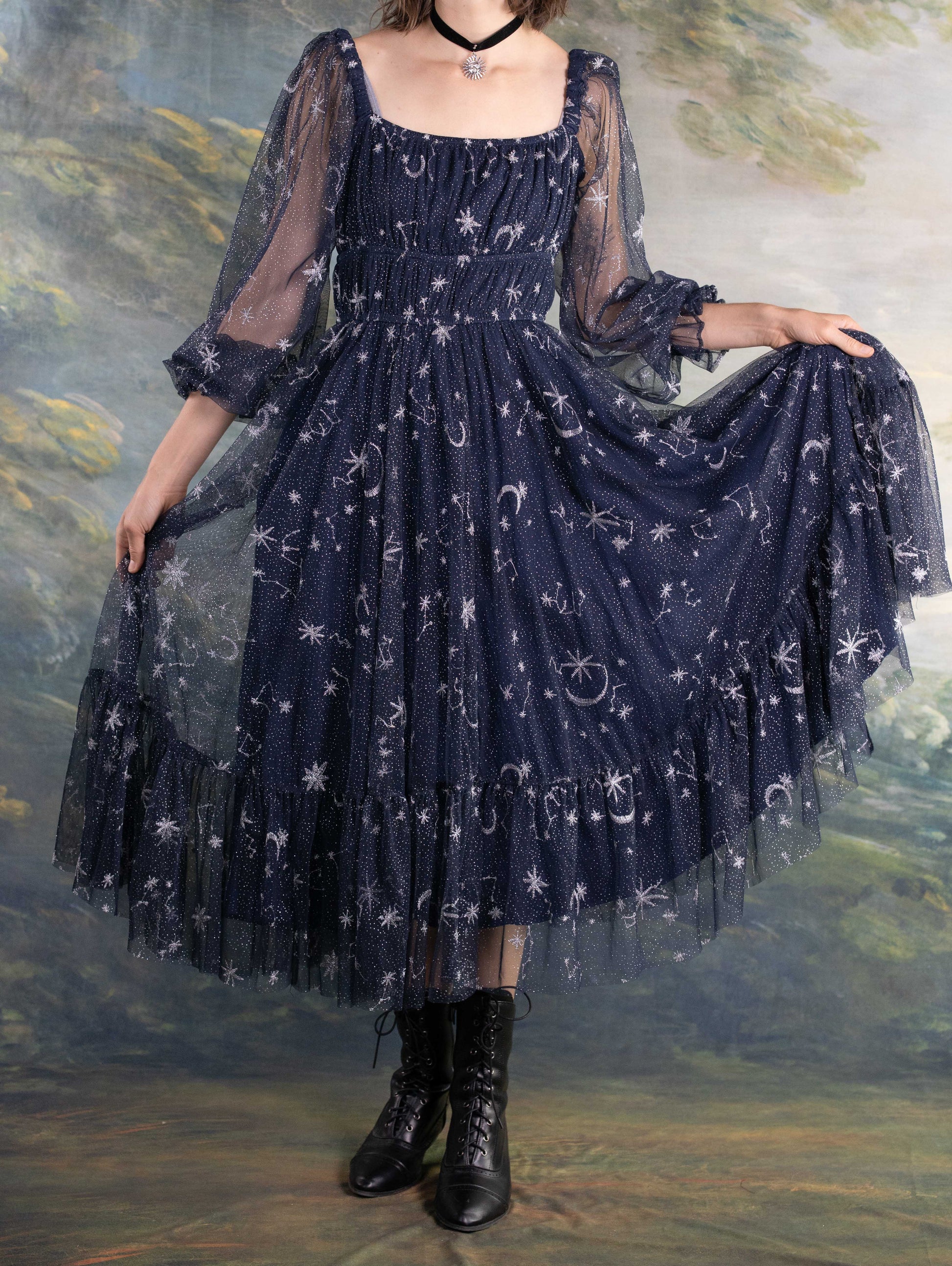Celestial Tulle Dress in navy with sheer star and moon patterns and puffed sleeves creating a dreamy celestial look.