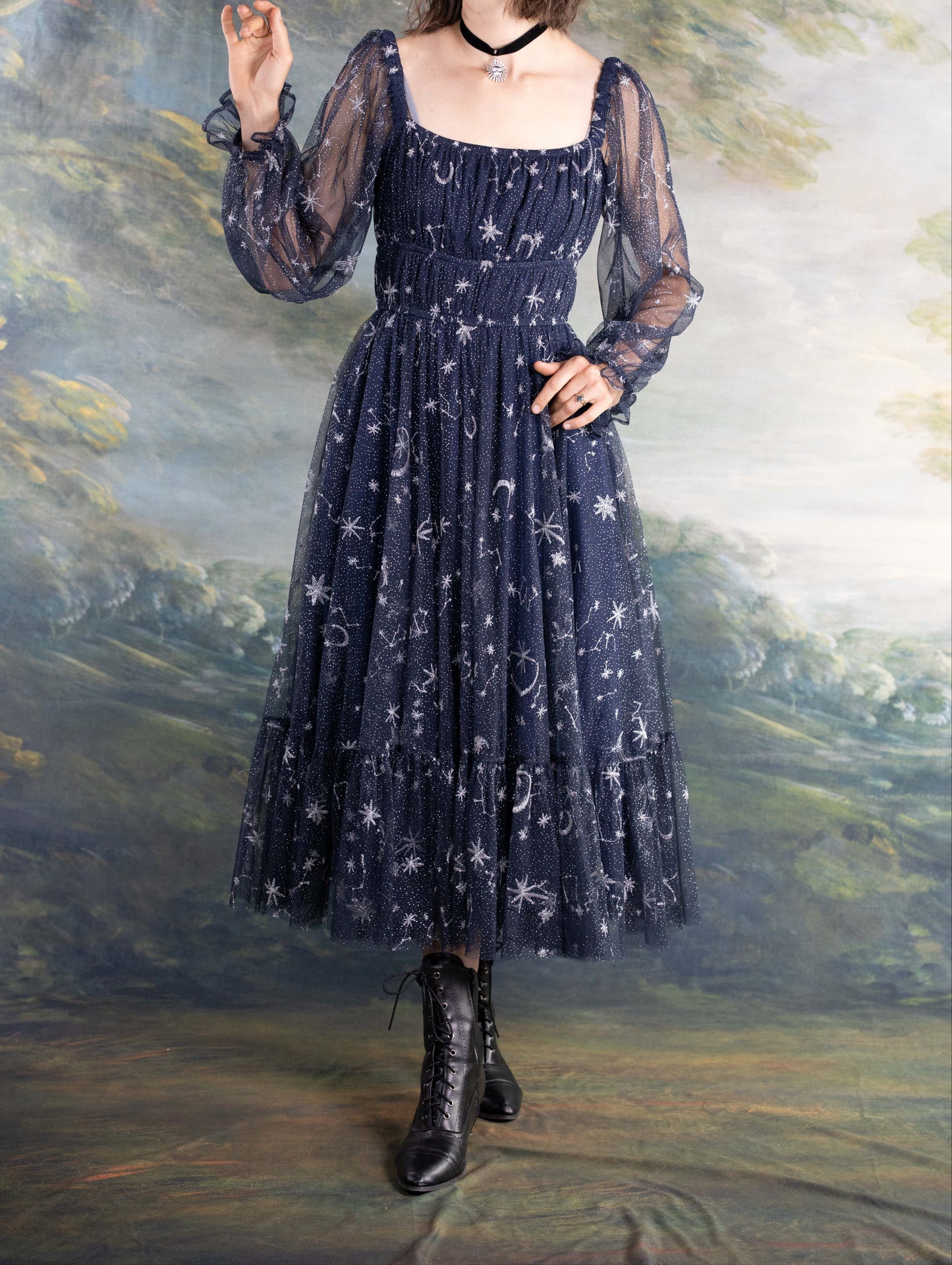 Celestial Tulle Dress in navy blue with sheer sleeves and celestial star and moon patterns on flowing fabric.