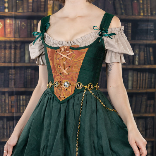 Handmade Dark Green and Copper Paisley Corset with Arms Cuffs worn over off-shoulder blouse and green skirt.