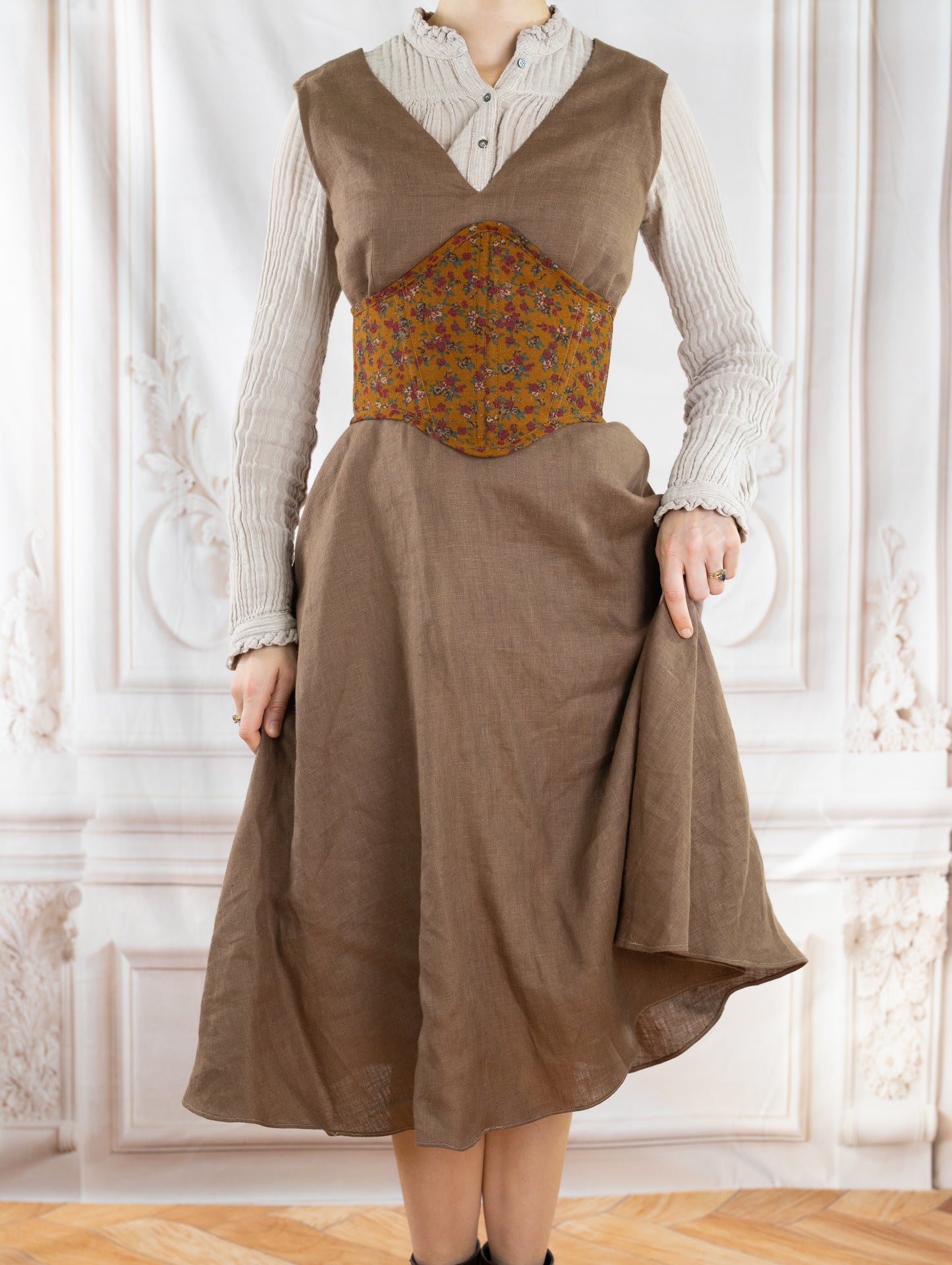 Woman wearing a floral corset belt made using the Corset Belt PDF Sewing Pattern over a beige dress and blouse