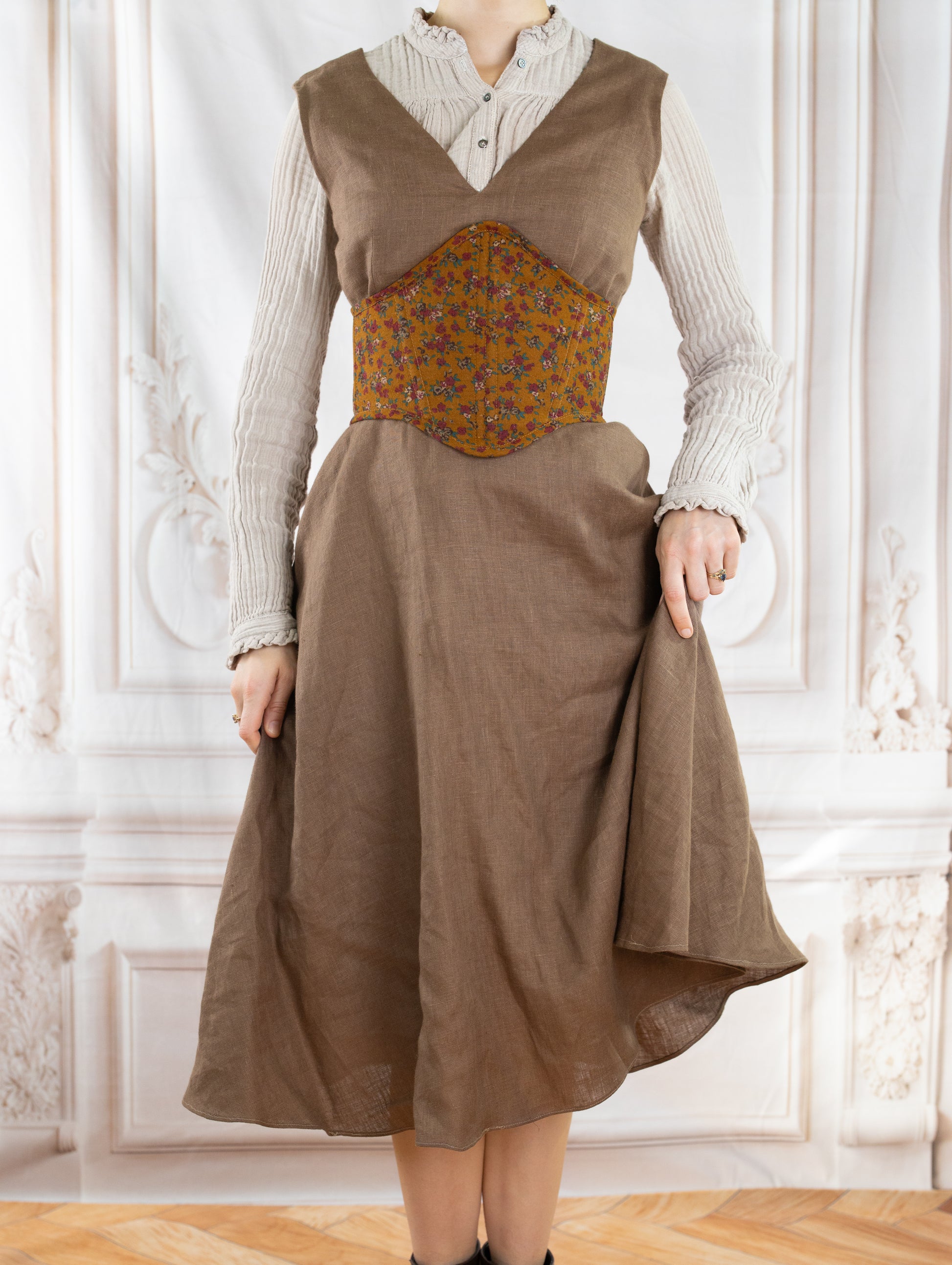 Woman wearing a floral corset belt made using the Corset Belt PDF Sewing Pattern over a beige dress and blouse
