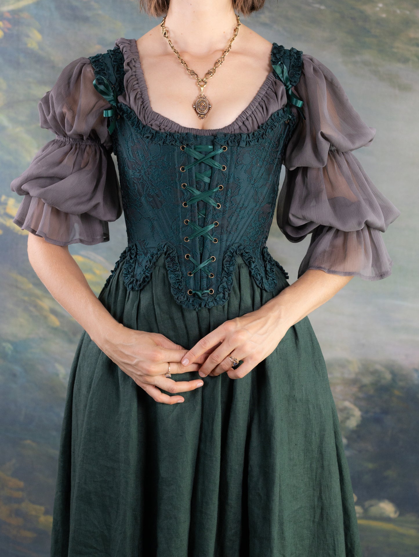 Woman wearing Dark Green Floral Jacquard 18th Century Stays with lace-up front and ruffled neckline details