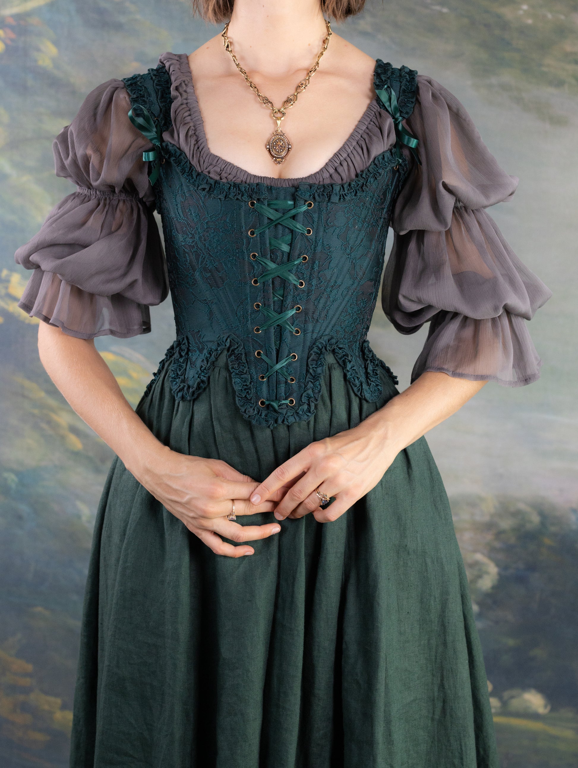 Woman wearing Dark Green Floral Jacquard 18th Century Stays with lace-up front and ruffled neckline details