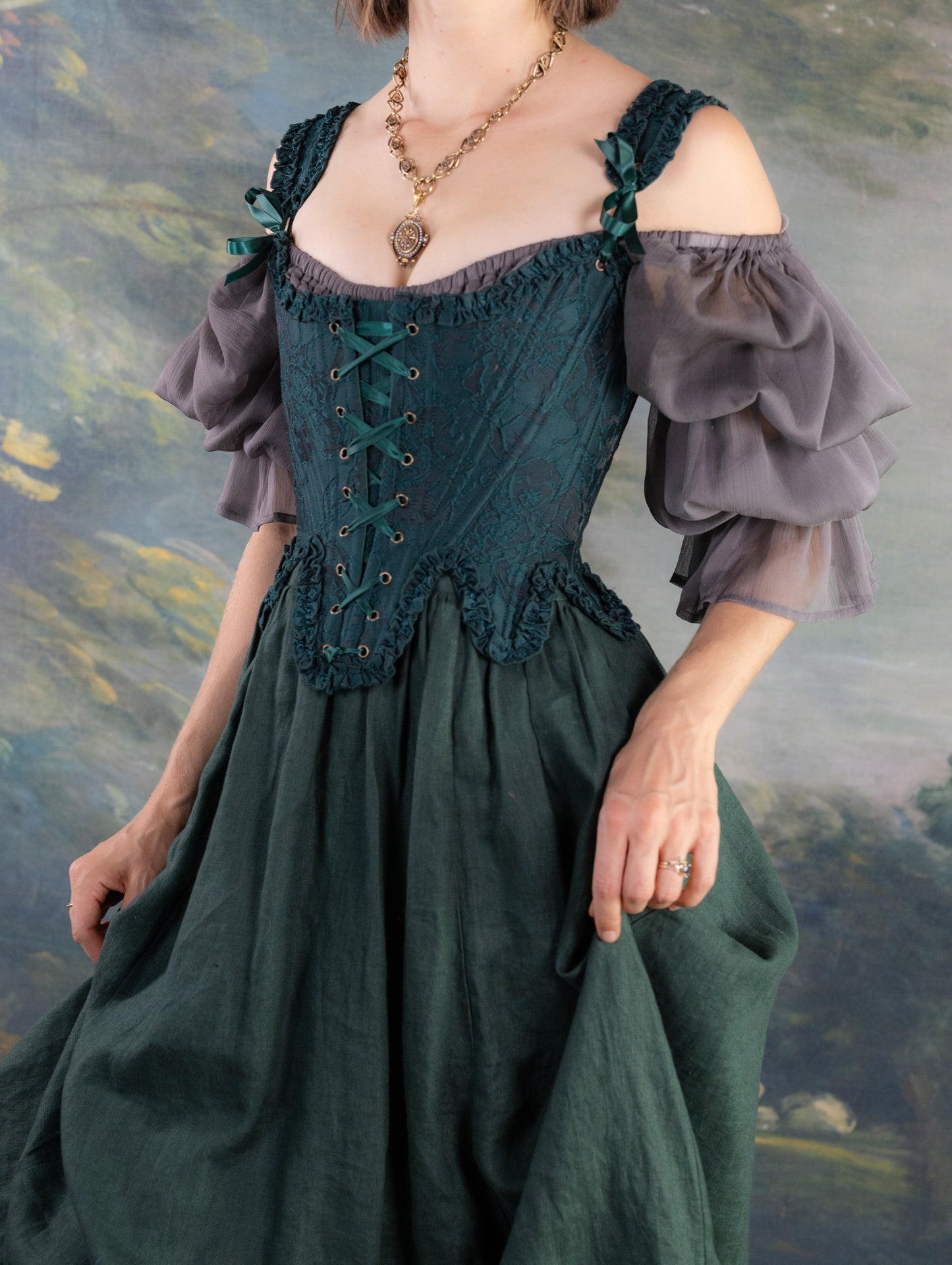 Dark Green Floral Jacquard 18th Century Stays with ruffled neckline, laced front, worn over puffed sleeve blouse and long skirt