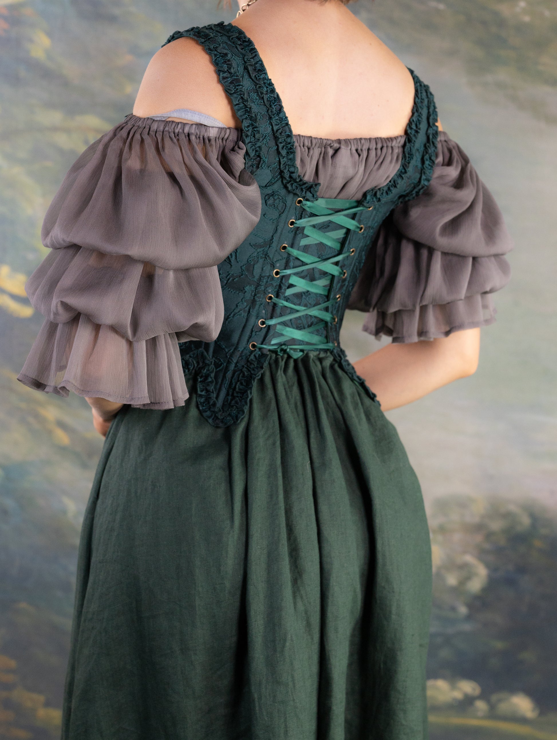 Dark Green Floral Jacquard 18th Century Stays shown from the back with intricate lacing and ruffled neckline details