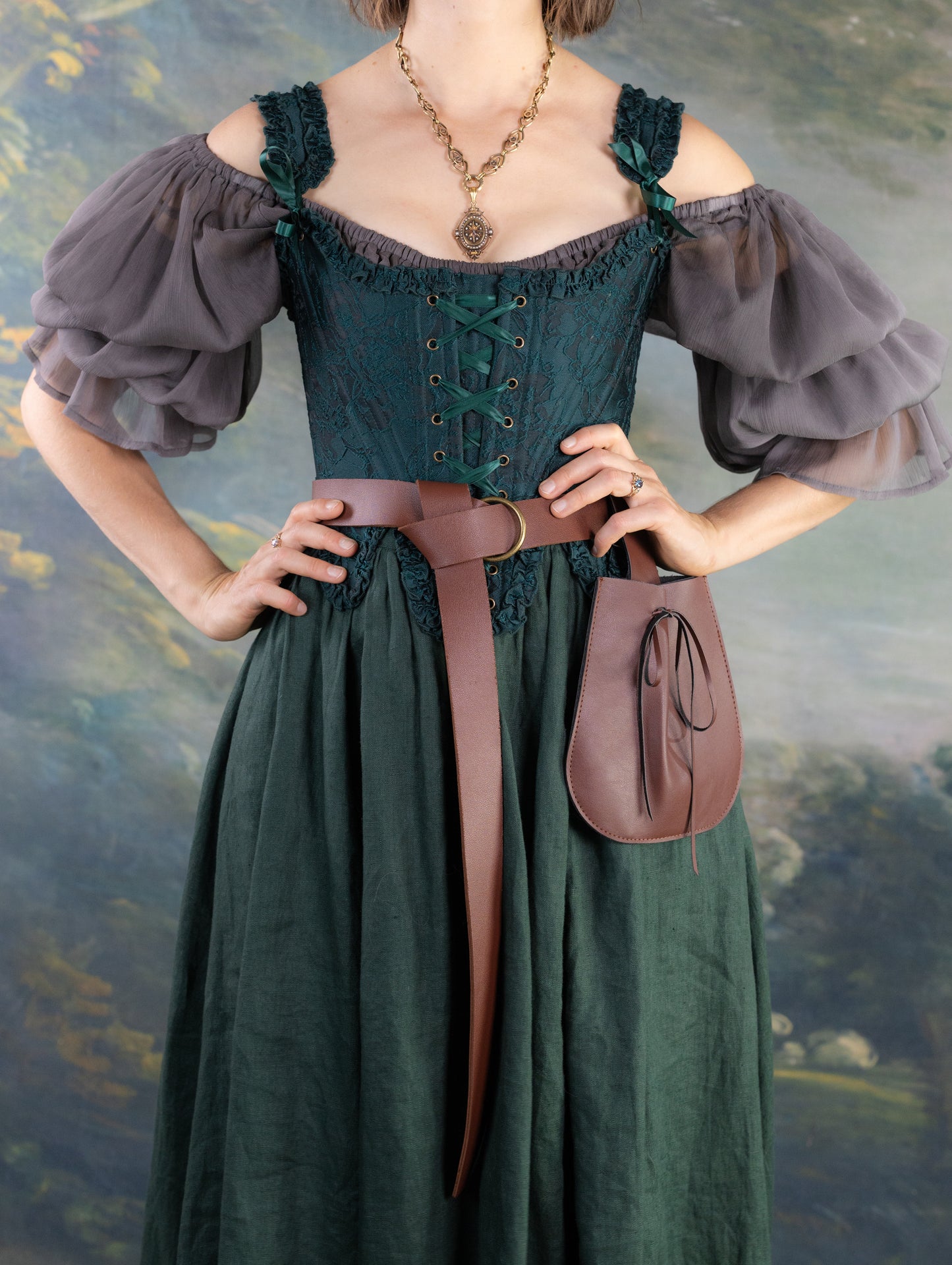 Dark Green Floral Jacquard 18th Century Stays with ruffle neckline and waist paired with billowy sheer sleeves and leather belt pouch
