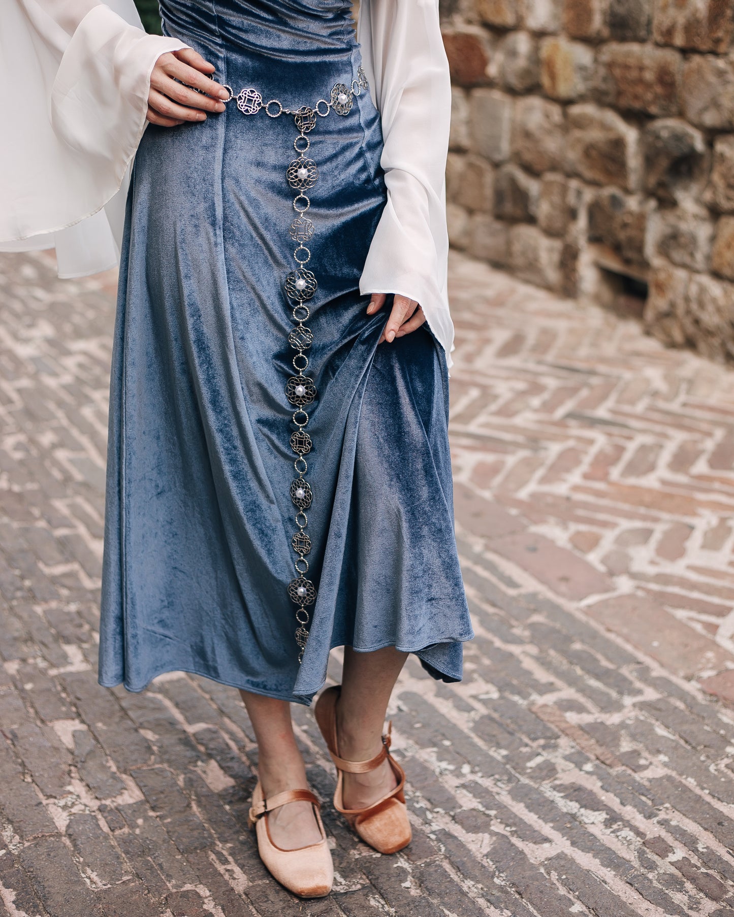 Rosette Medieval Chain Belt styled with Tudor rose medallions worn over a blue velvet skirt and light blouse
