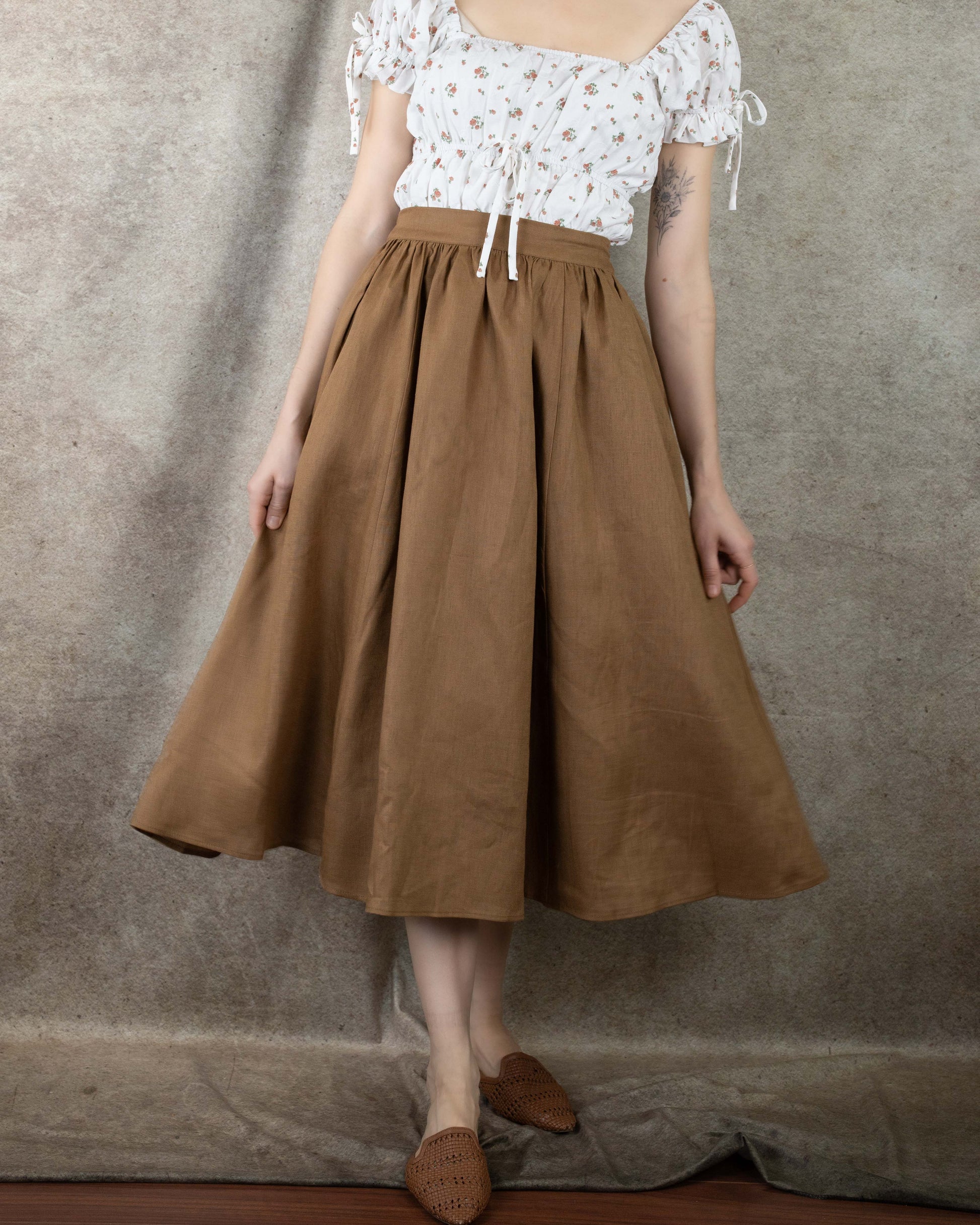 model wearing a brown calf length skirt