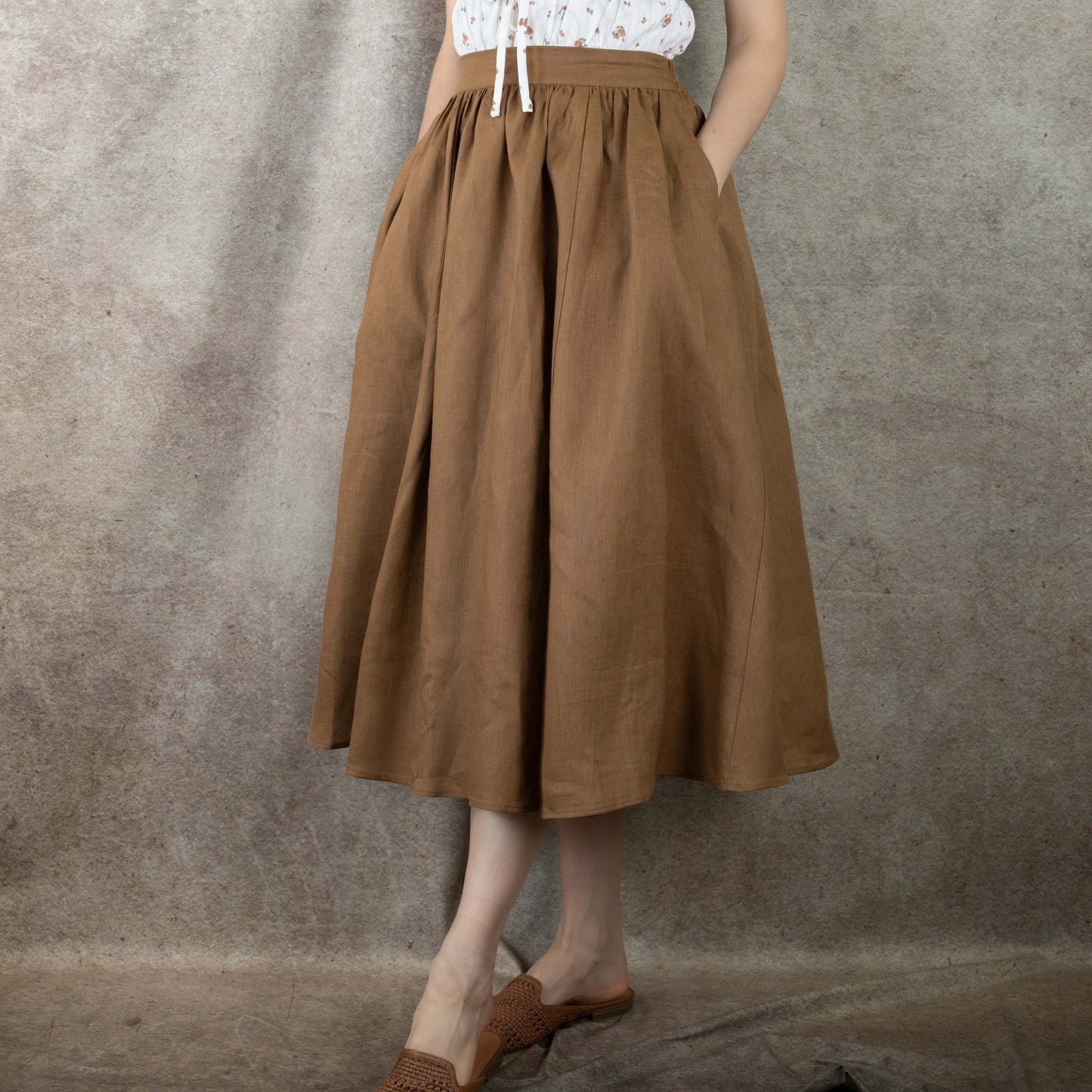 side view of model wearing ginger linen midi skirt