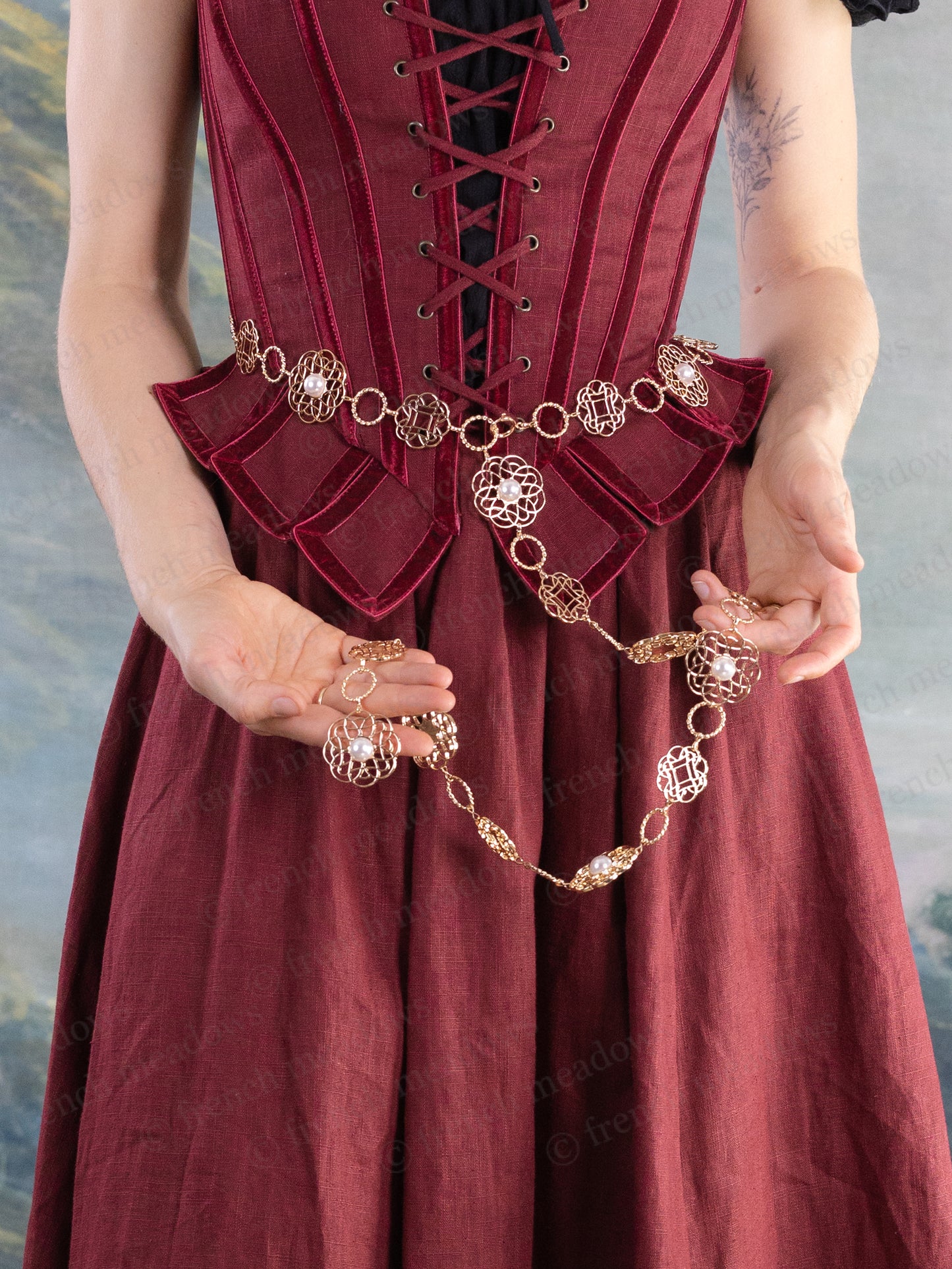 Rosette Medieval Chain Belt featuring intricate filigree rosette medallions worn over a deep red medieval-inspired dress