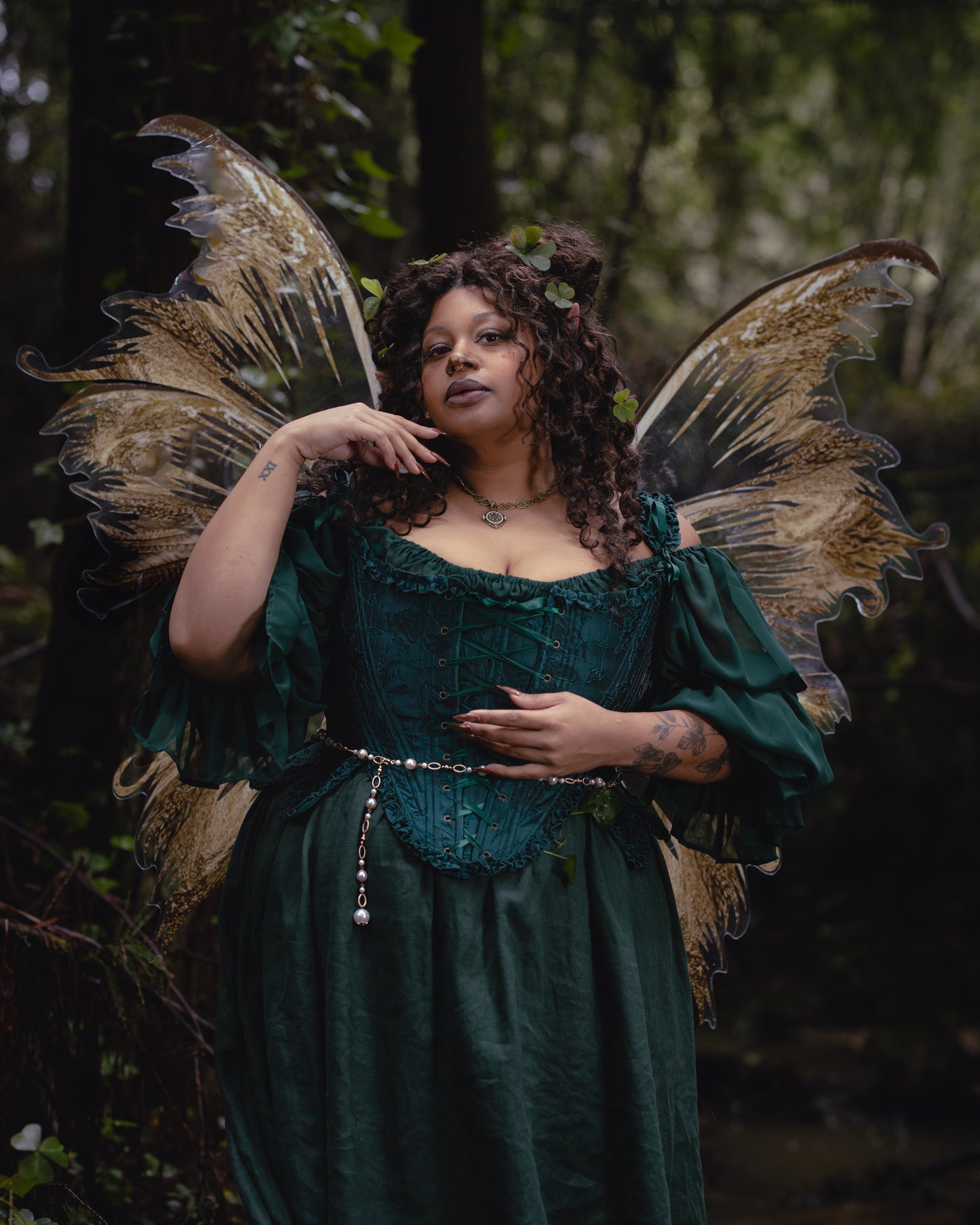 Woman wearing Dark Green Floral Jacquard 18th Century Stays with fairy wings in a forest setting