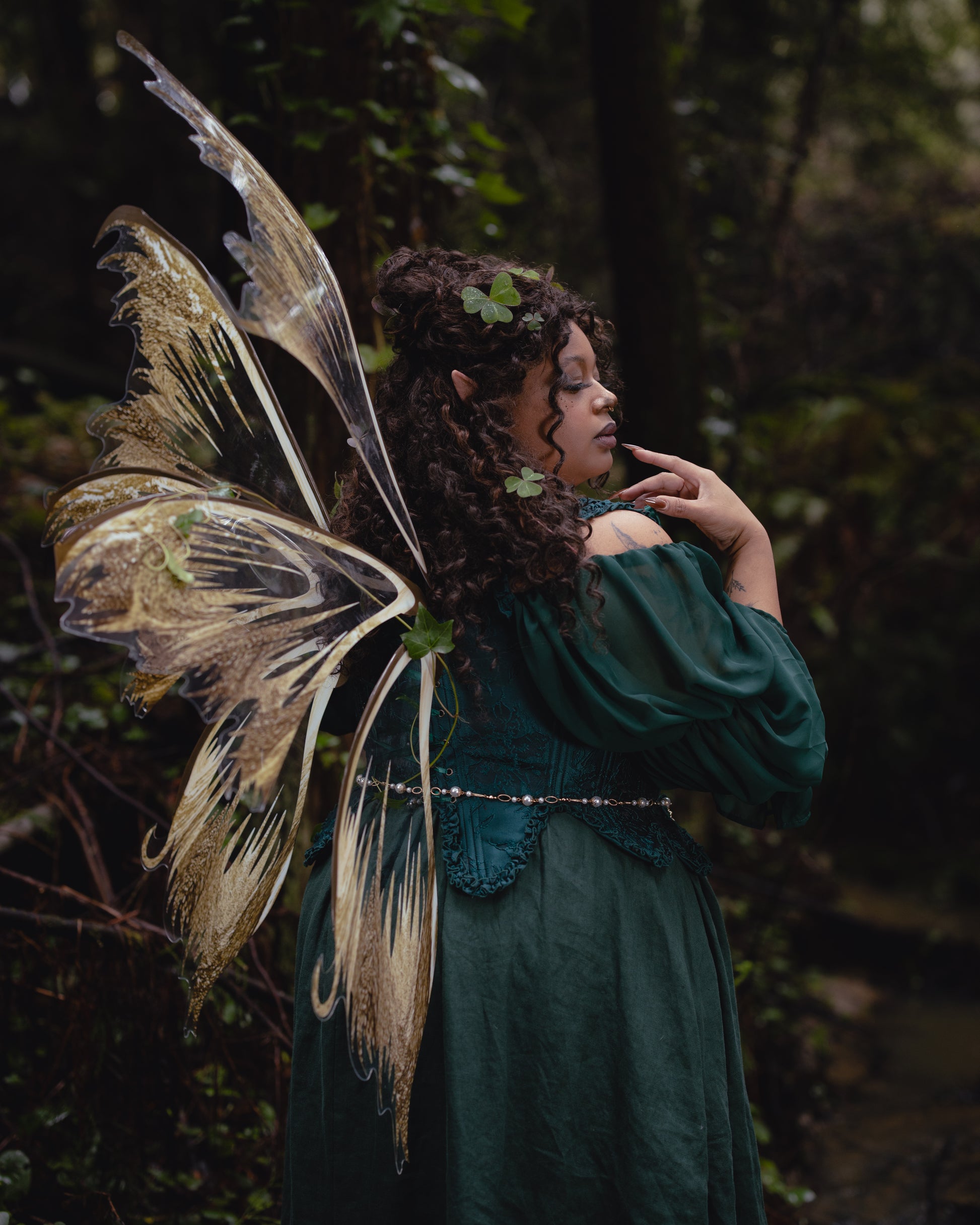 Woman with delicate fairy wings wearing Dark Green Floral Jacquard 18th Century Stays in a forest setting