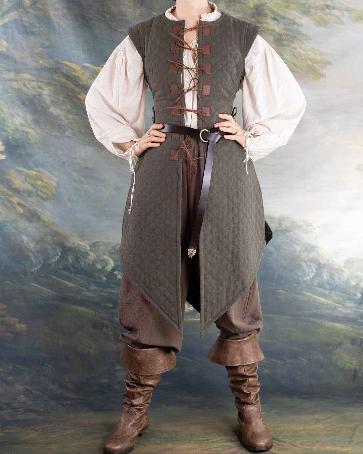 Woman wearing a historically inspired Quilted Gambeson with laced front and belt over vintage-style clothing