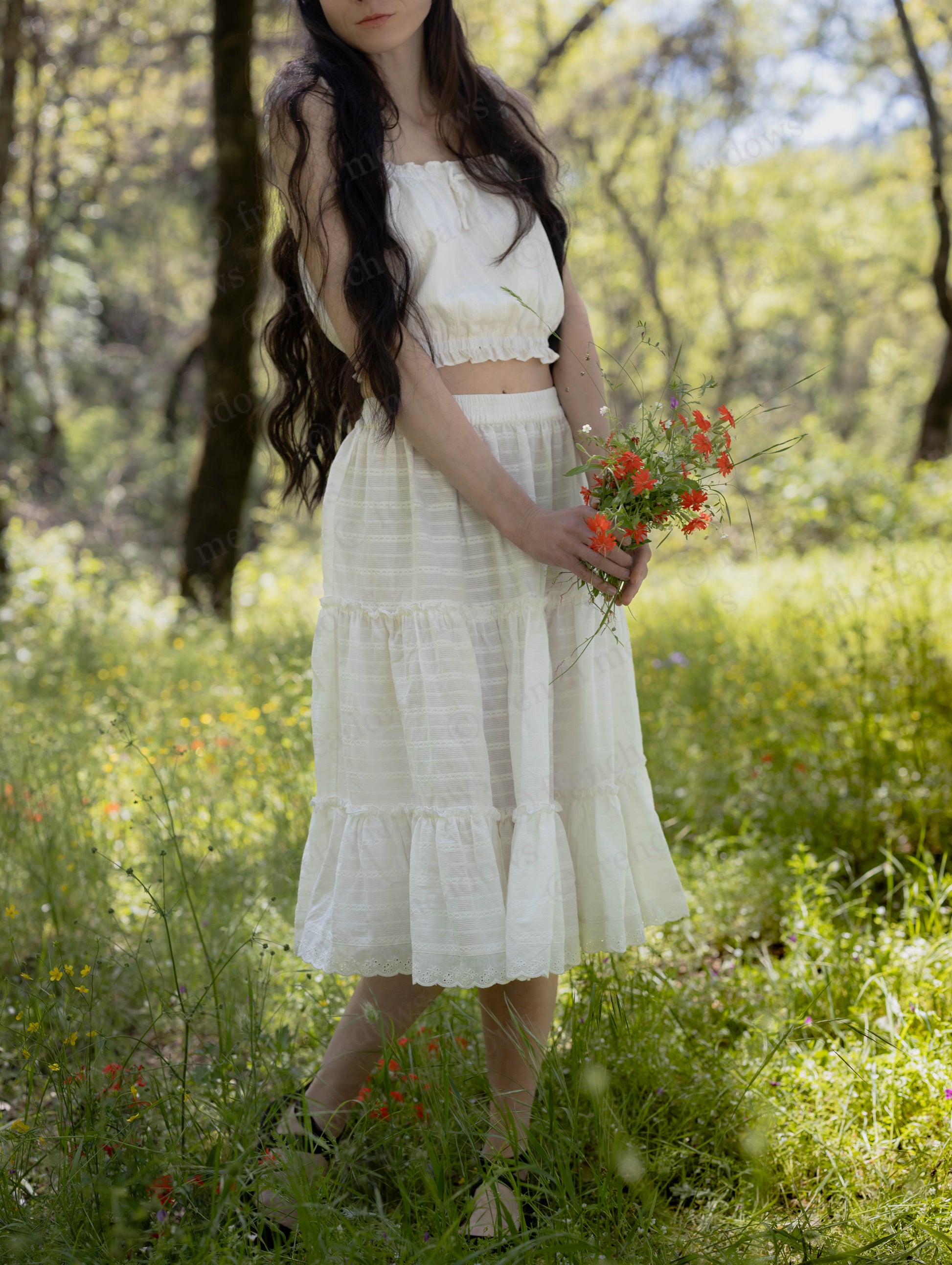 White Cotton Petticoat with three ruffled tiers, lace trim, and elastic waistband in a sunlit forest setting.