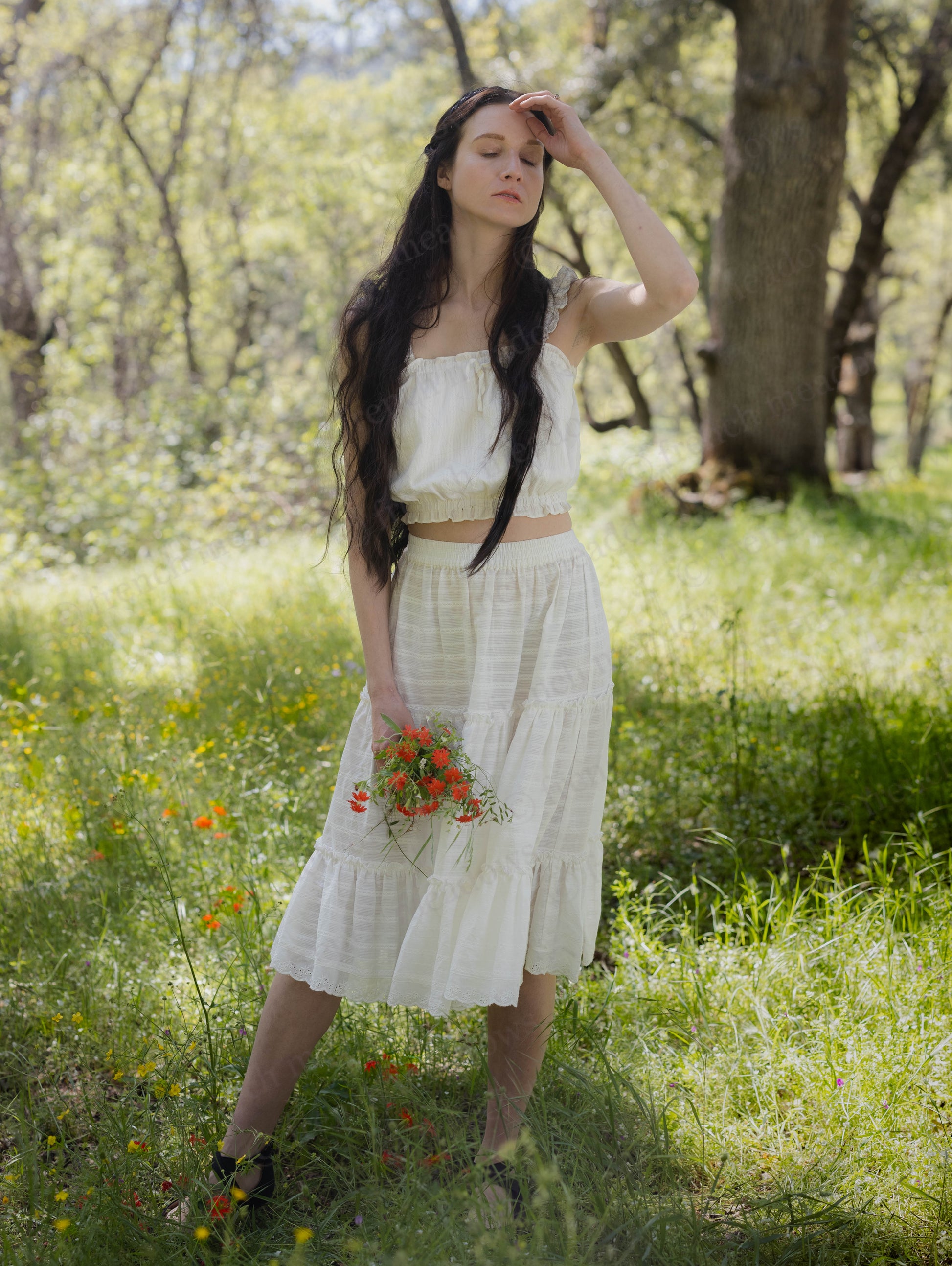 White Cotton Petticoat with three ruffled tiers and lace trim worn outdoors in natural sunlight.