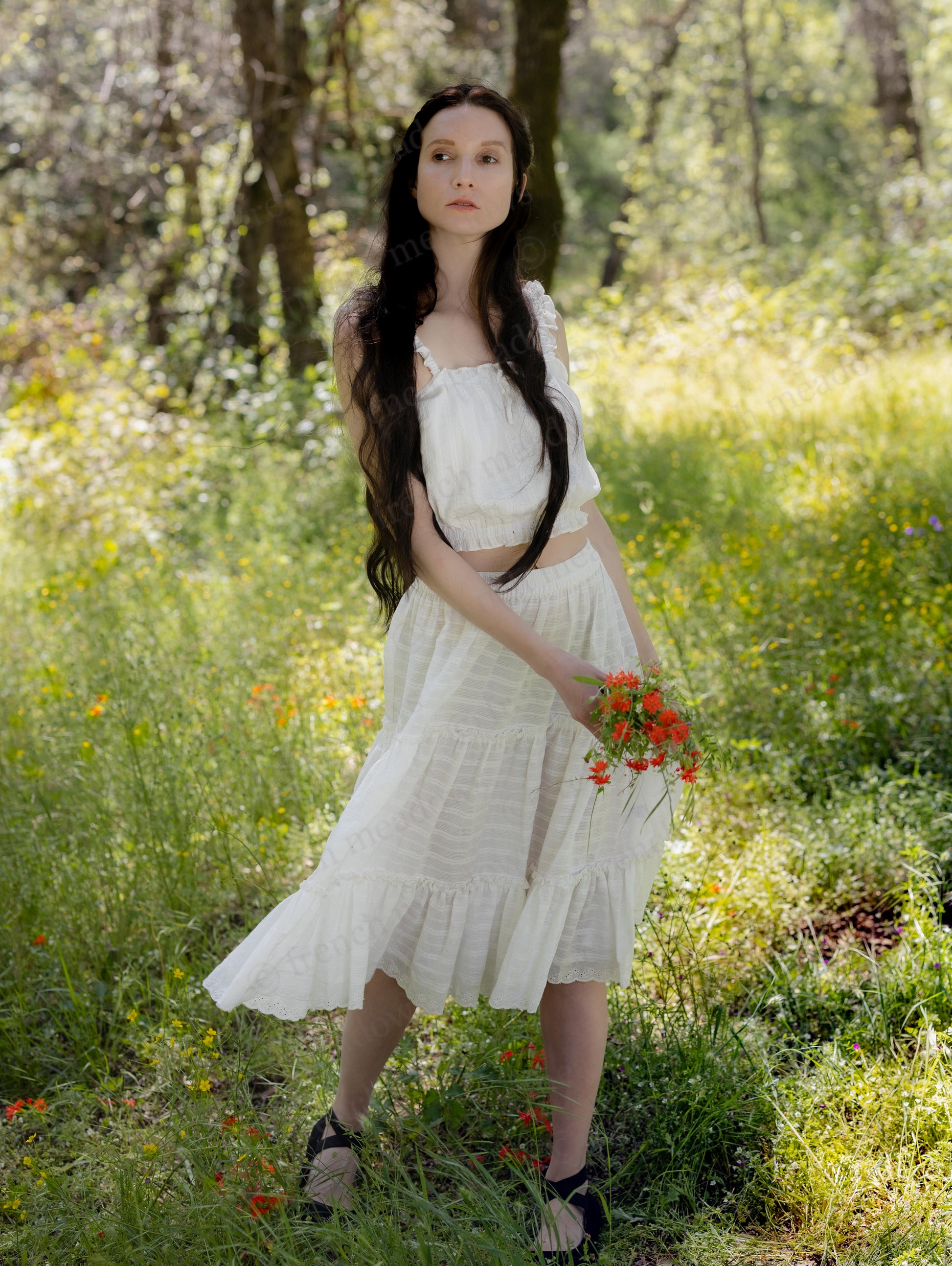 White Cotton Petticoat with three-tier ruffles and lace trim worn by woman in a sunlit forest holding red flowers.