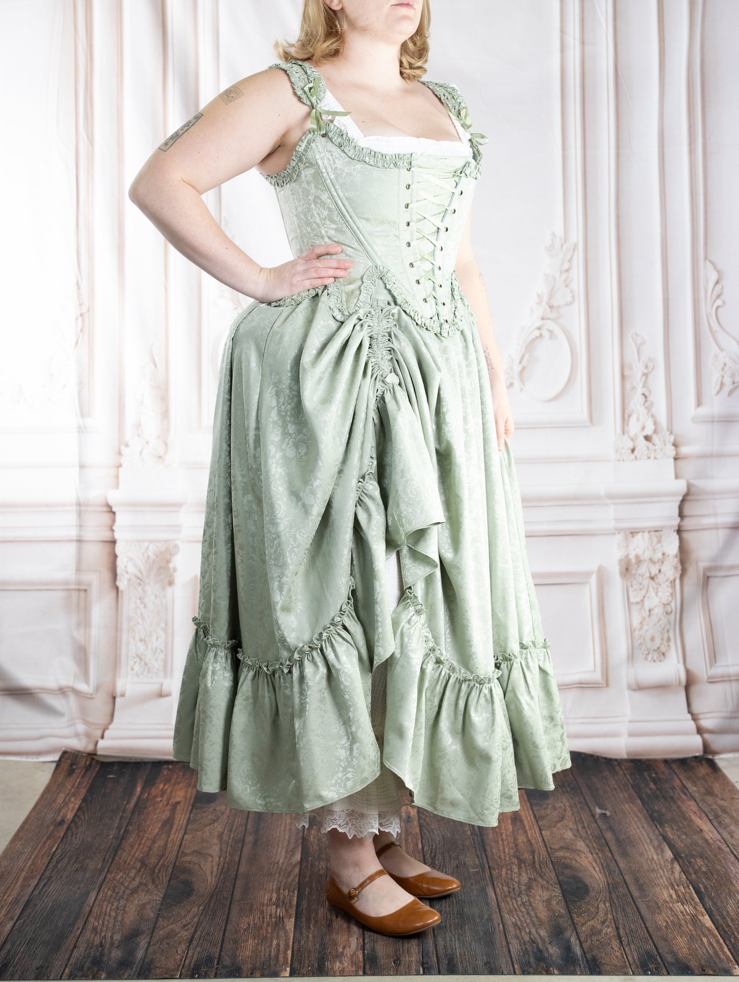 Woman wearing a vintage style pale green Mint Floral Ruffle Skirt with subtle floral pattern and ruffled details
