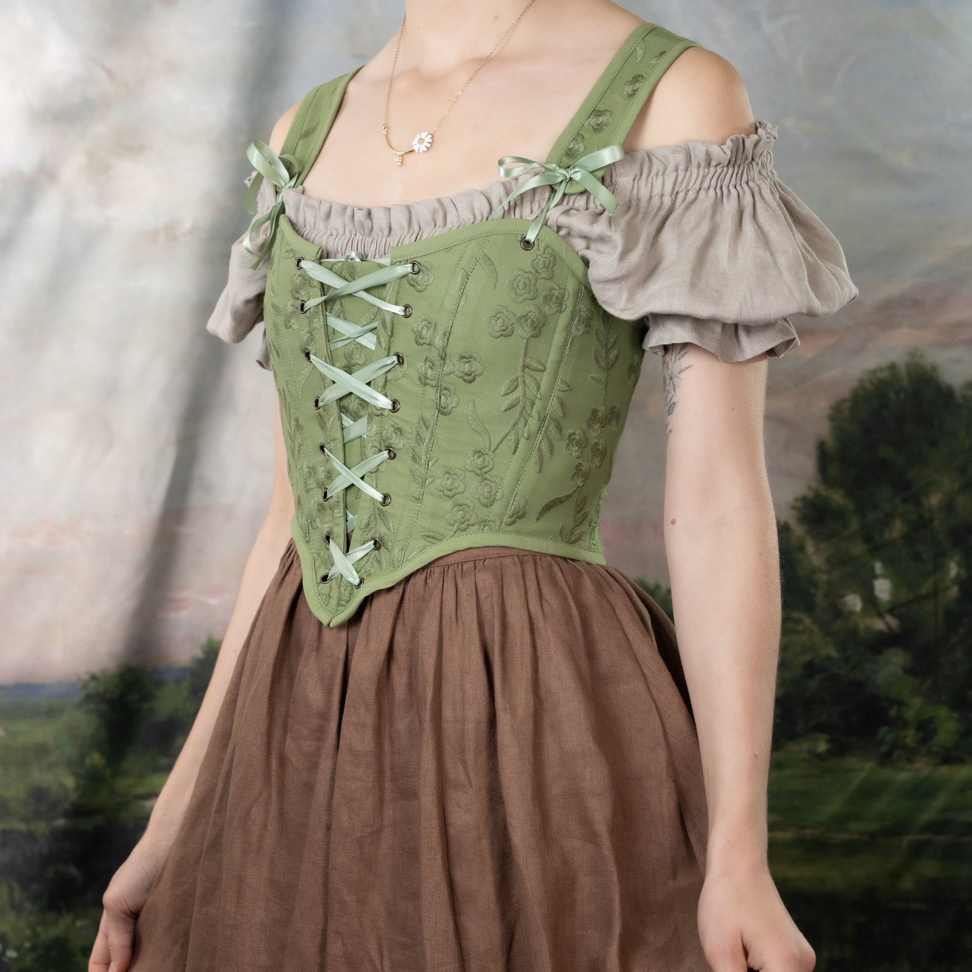 Moss Green Embroidered Floral Corset Top with off-shoulder puff sleeves, front lacing, and delicate floral embroidery pattern