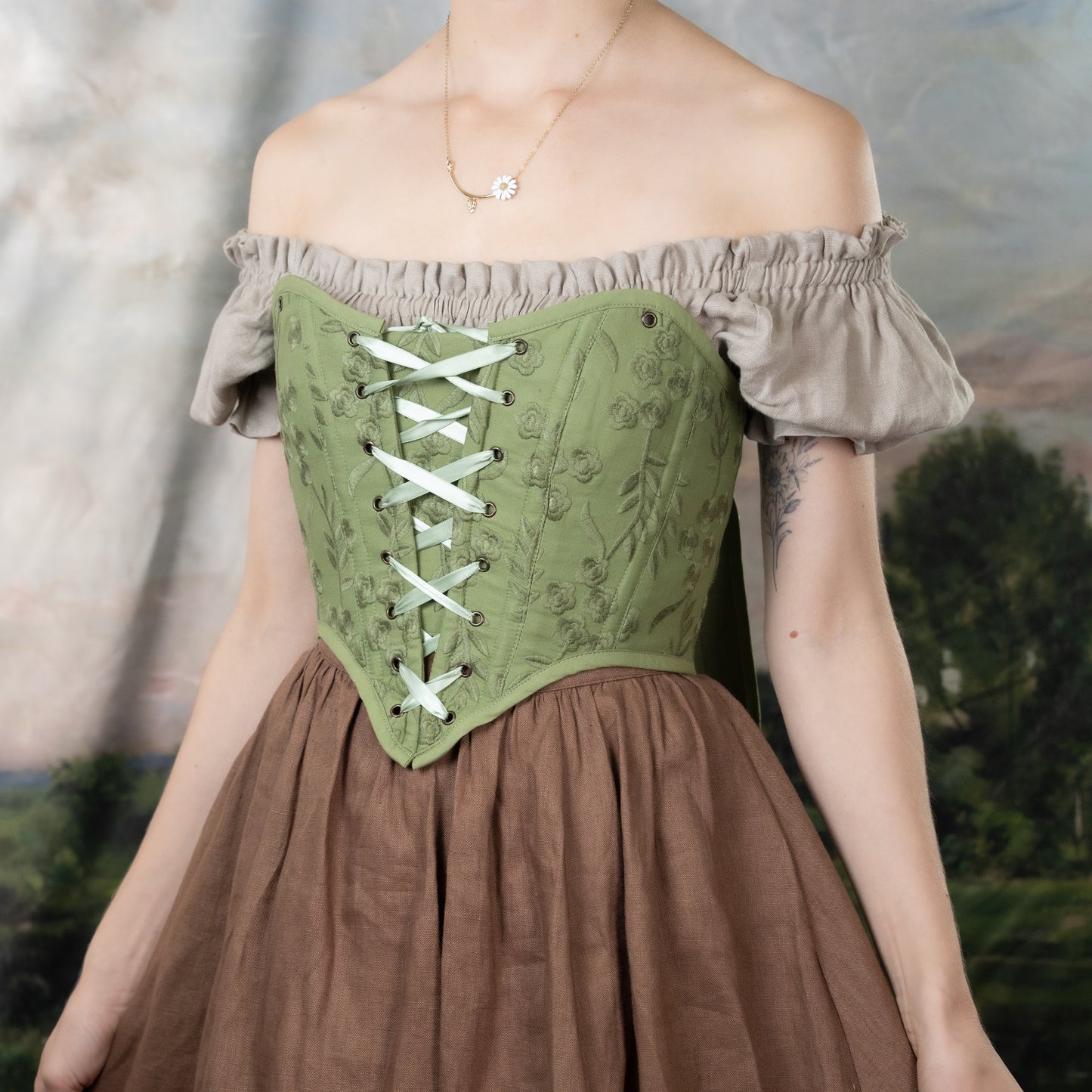 Moss Green Embroidered Floral Corset Top with off-shoulder design, lace-up front, and delicate floral embroidery on sage fabric
