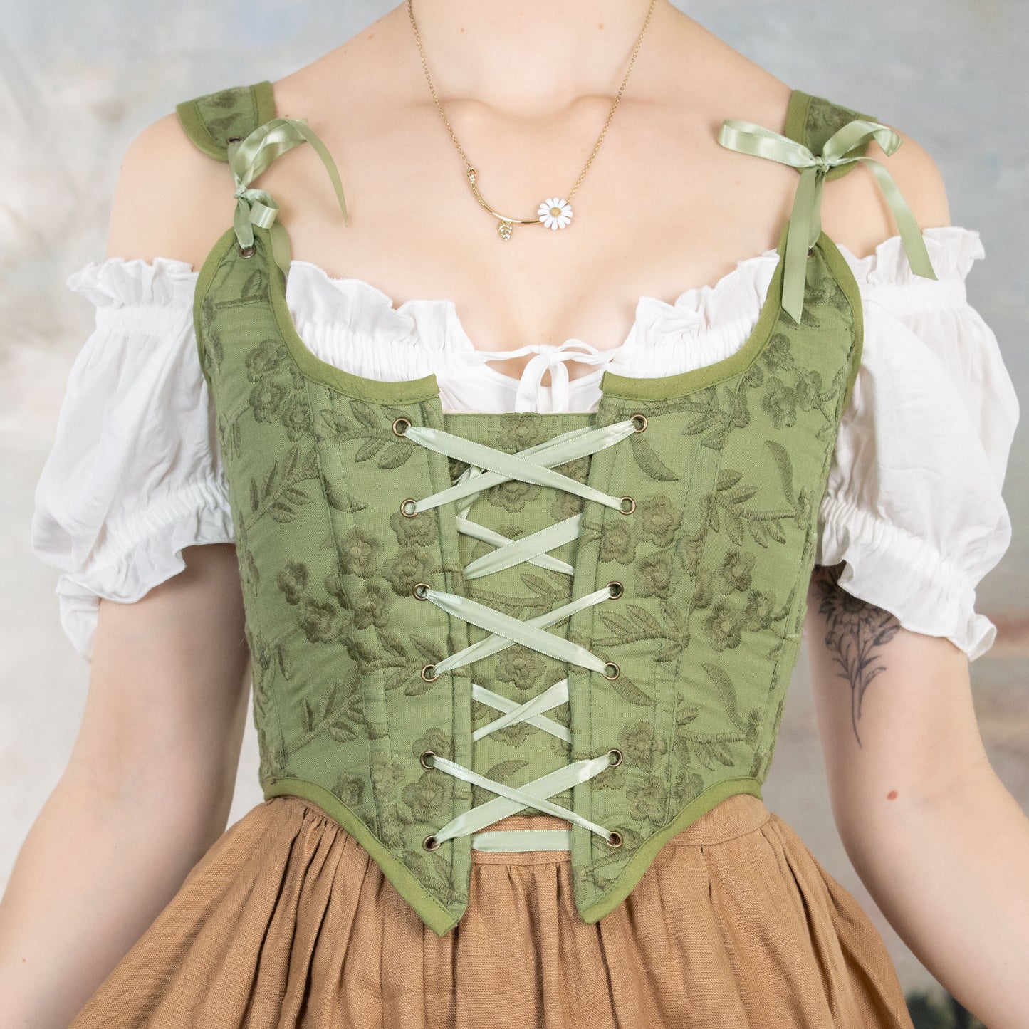 Handmade Moss Green Embroidered Floral Corset with lace-up front and delicate ribbon shoulder ties over white blouse