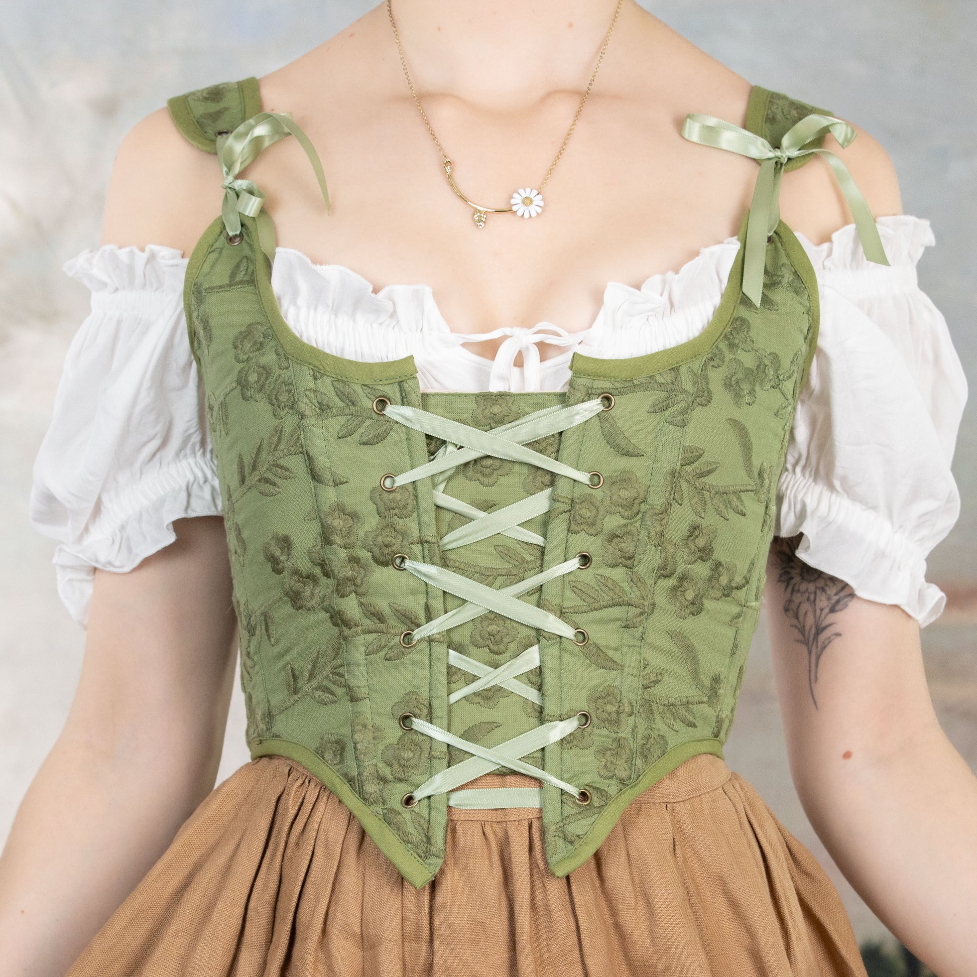Handmade Moss Green Embroidered Floral Corset with lace-up front and delicate ribbon shoulder ties over white blouse