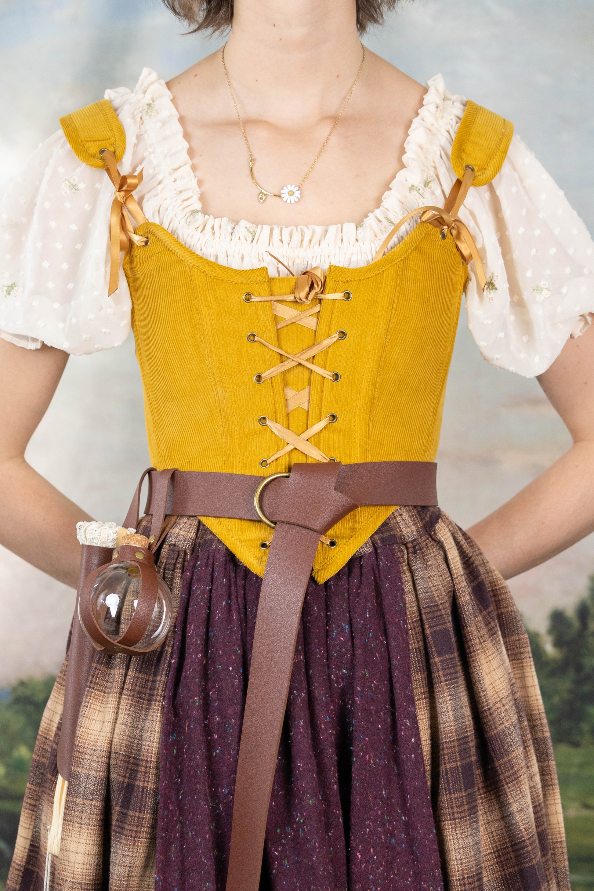 Handmade Mustard Corduroy Renaissance Corset worn over a white ruffled blouse with a brown belt and plaid skirt.