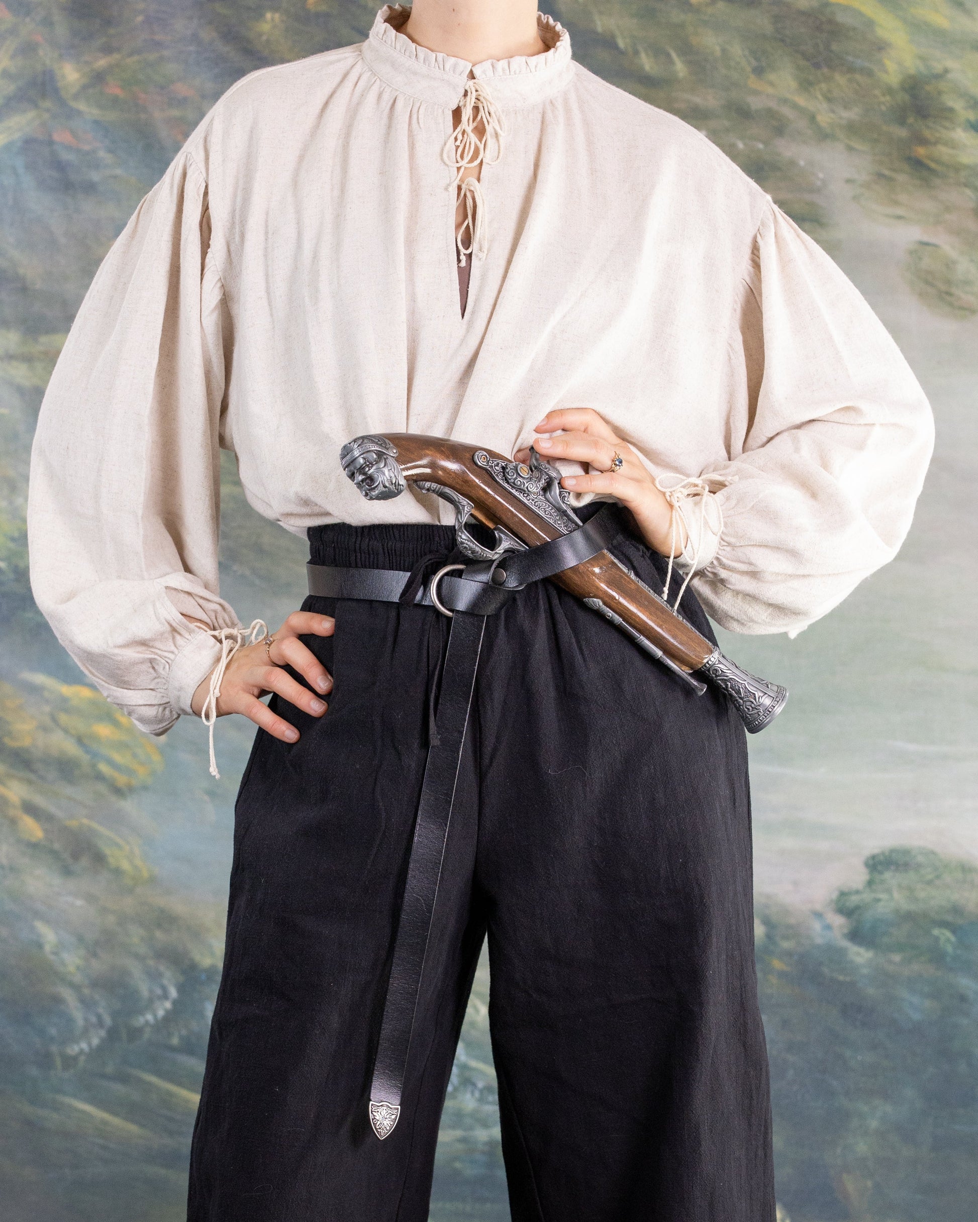 Borgia Shirt featuring soft linen fabric with Renaissance-inspired loose sleeves and gathered neckline, styled with high-waist pants.