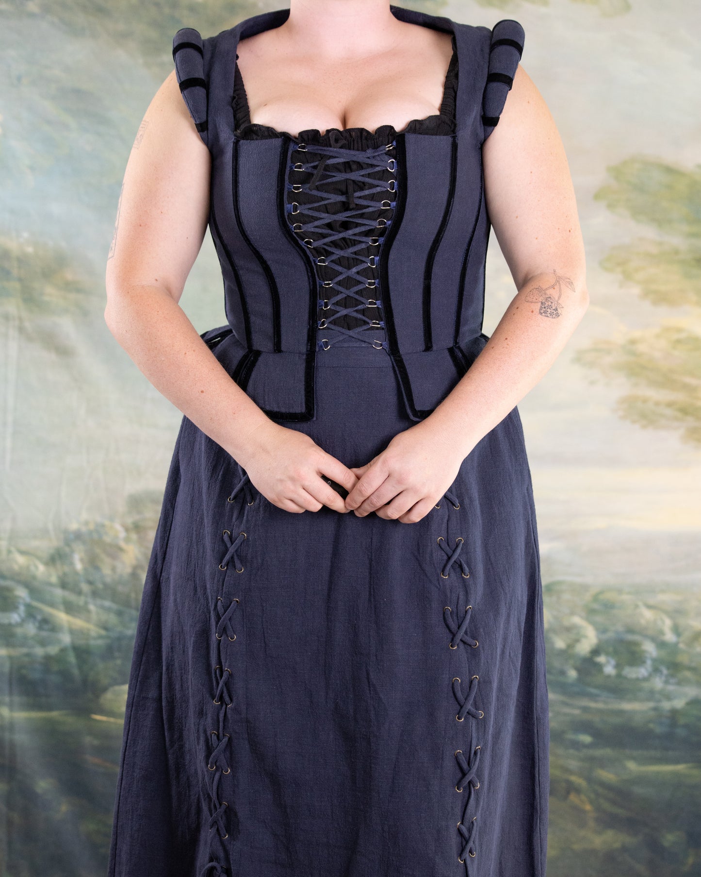 Front view of Navy Tavern Bodice with D-ring lace-up and adjustable back over matching navy skirt with lacing details