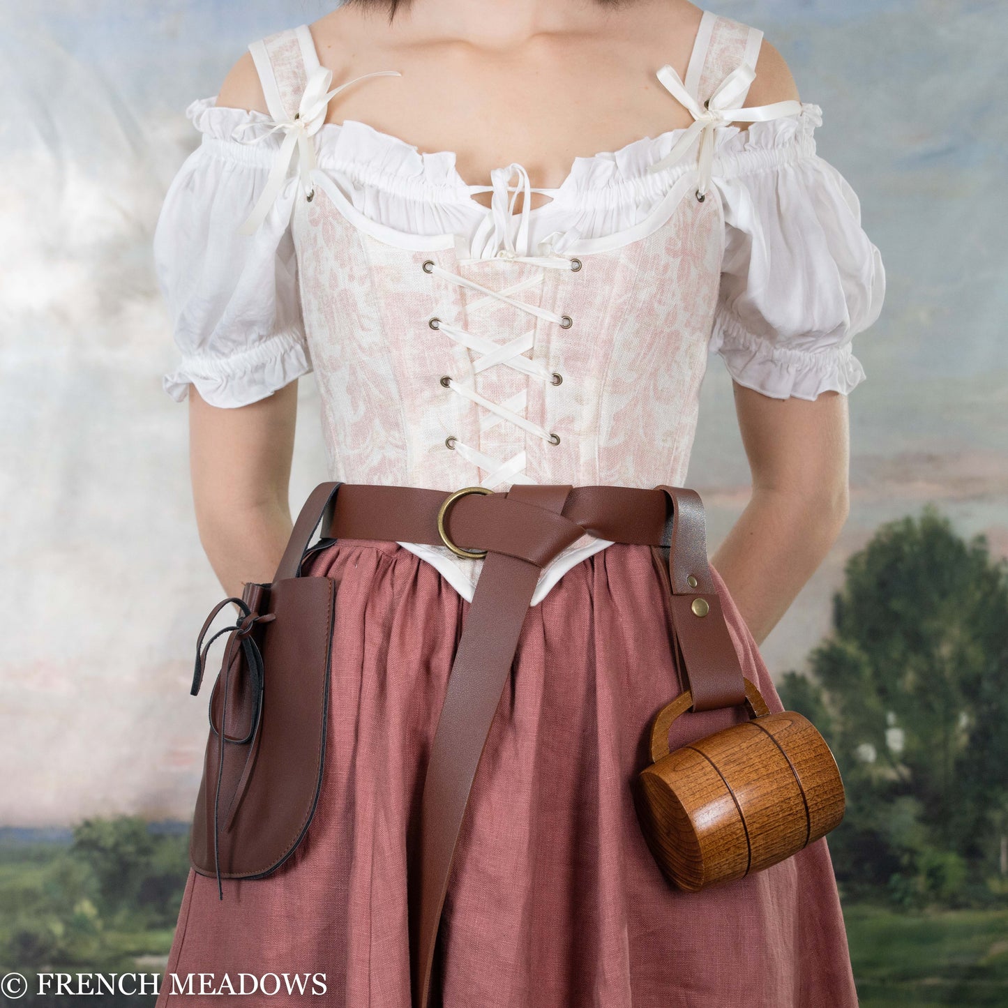 model wearing a women's renaissance faire costume with belt and accessories